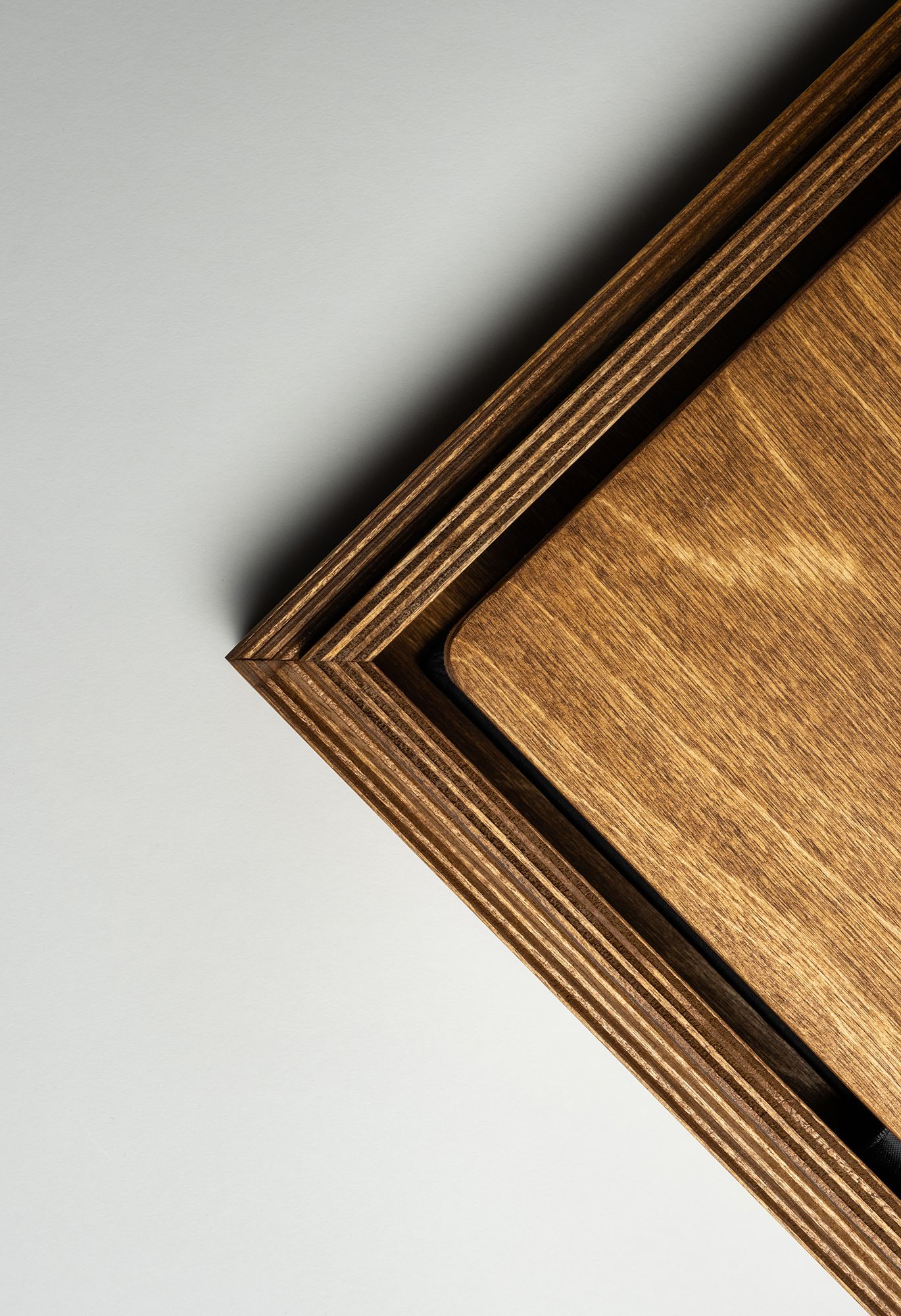 A diagonal pattern of layered wooden boards with a golden brown finish creates a geometric stair-step design.