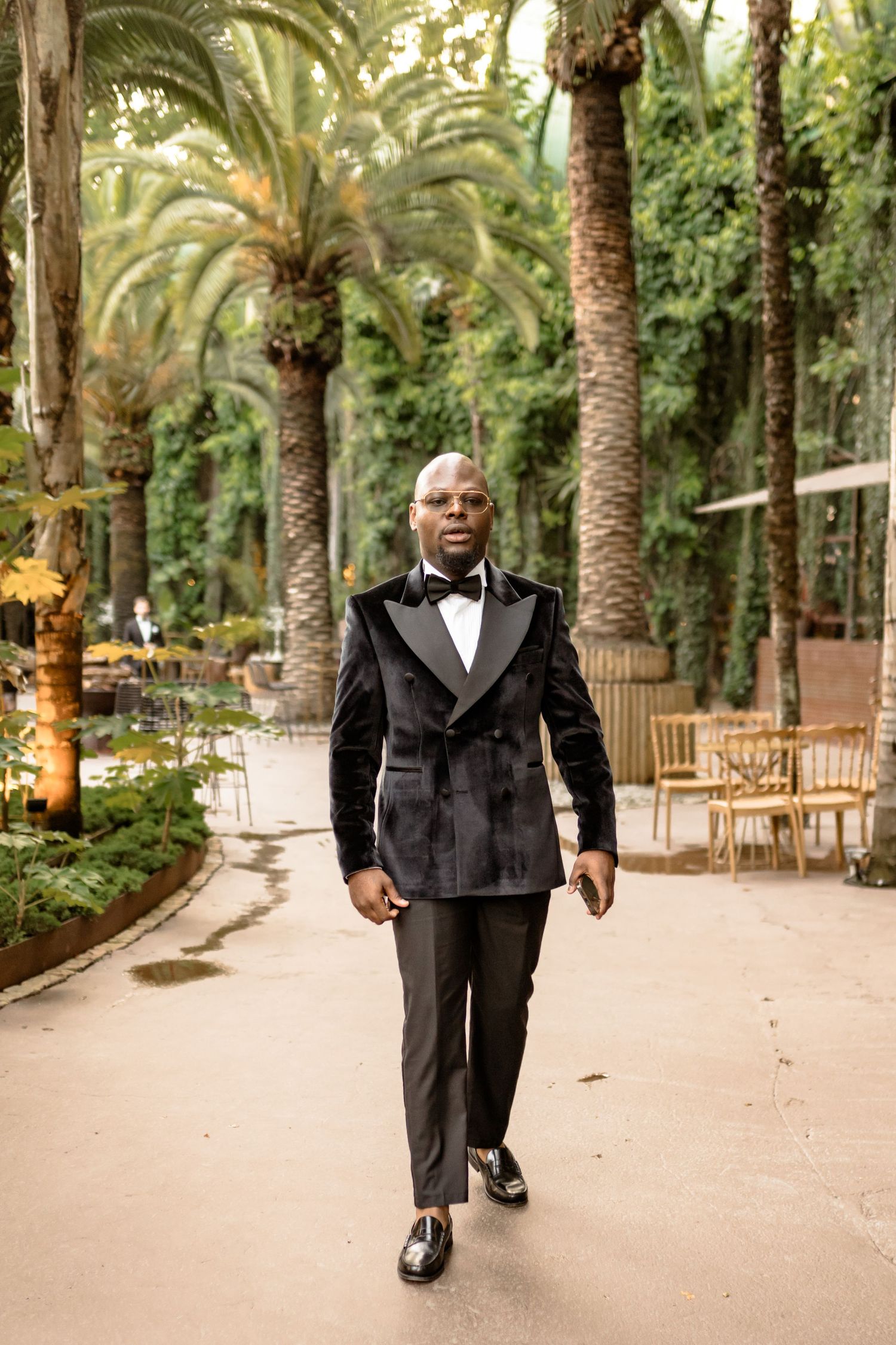 Palm tree-lined pathway at an elegant outdoor venue.