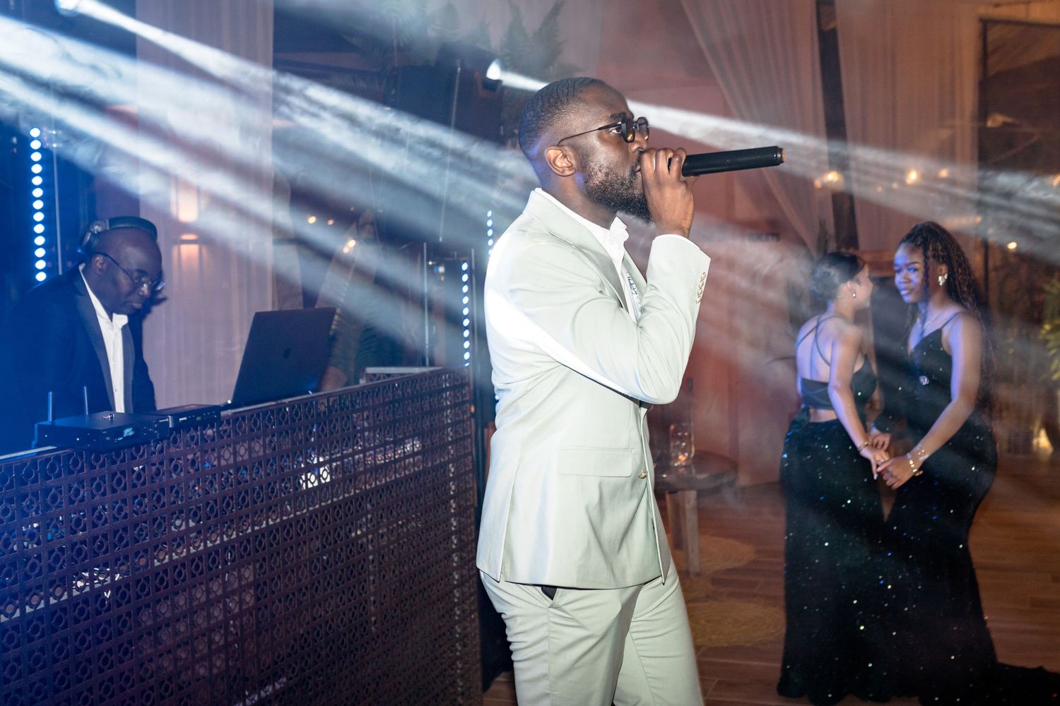 Dance floor scene with dramatic lighting and fog effects at an evening wedding reception.