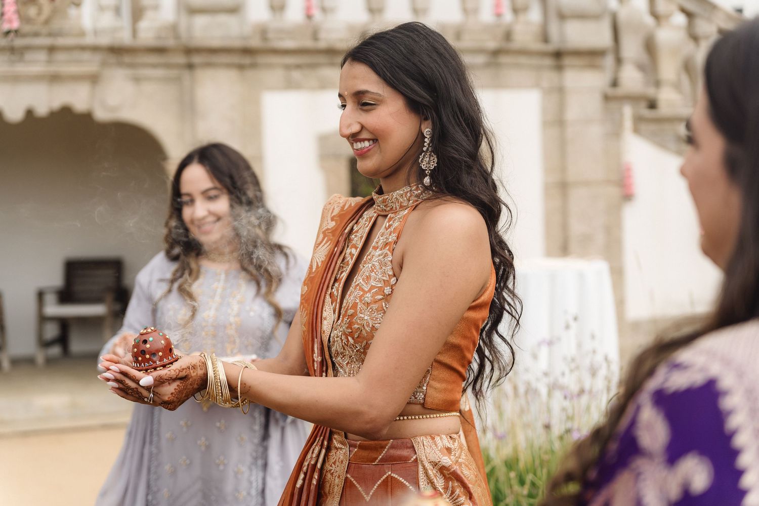 Festive gathering showing traditional South Asian attire in warm earth tones.