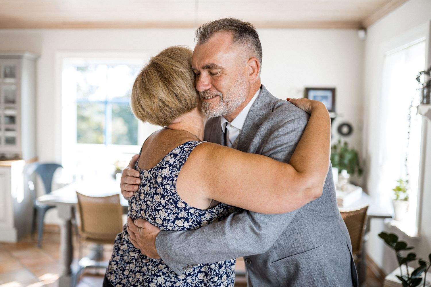 A series of emotional embraces shown in a sequence of photos taken in a bright interior setting.
