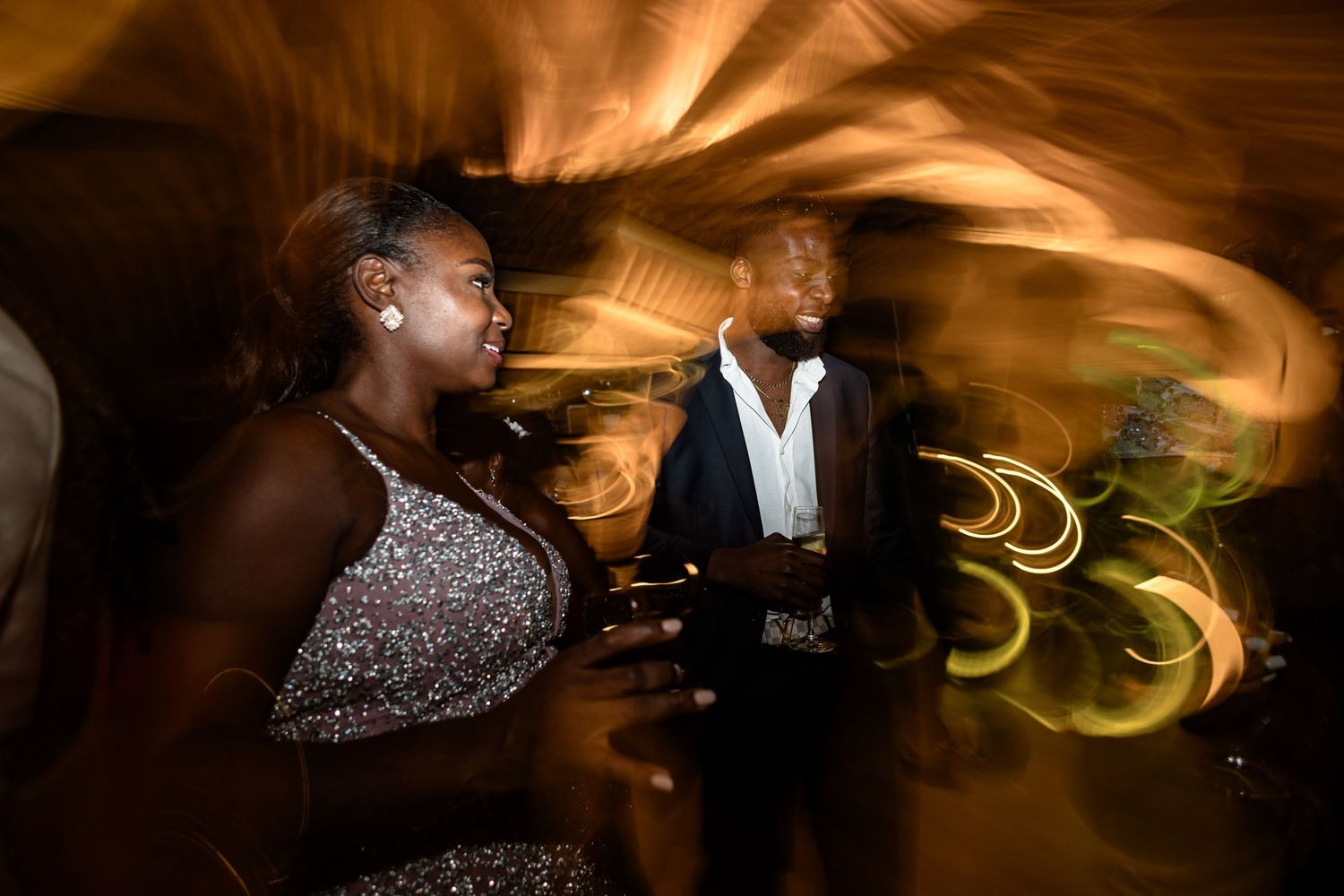 Artistic motion blur photo of couple dancing at evening reception.