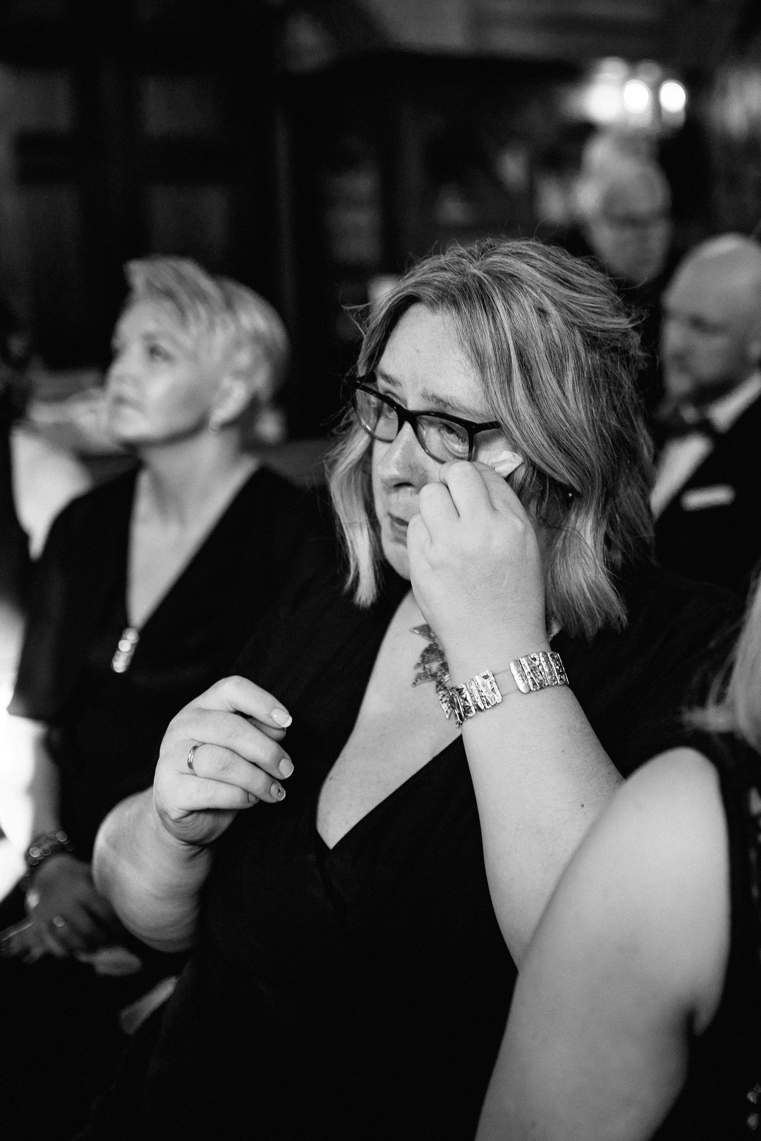 Black and white photos capturing emotional reactions during a wedding ceremony.