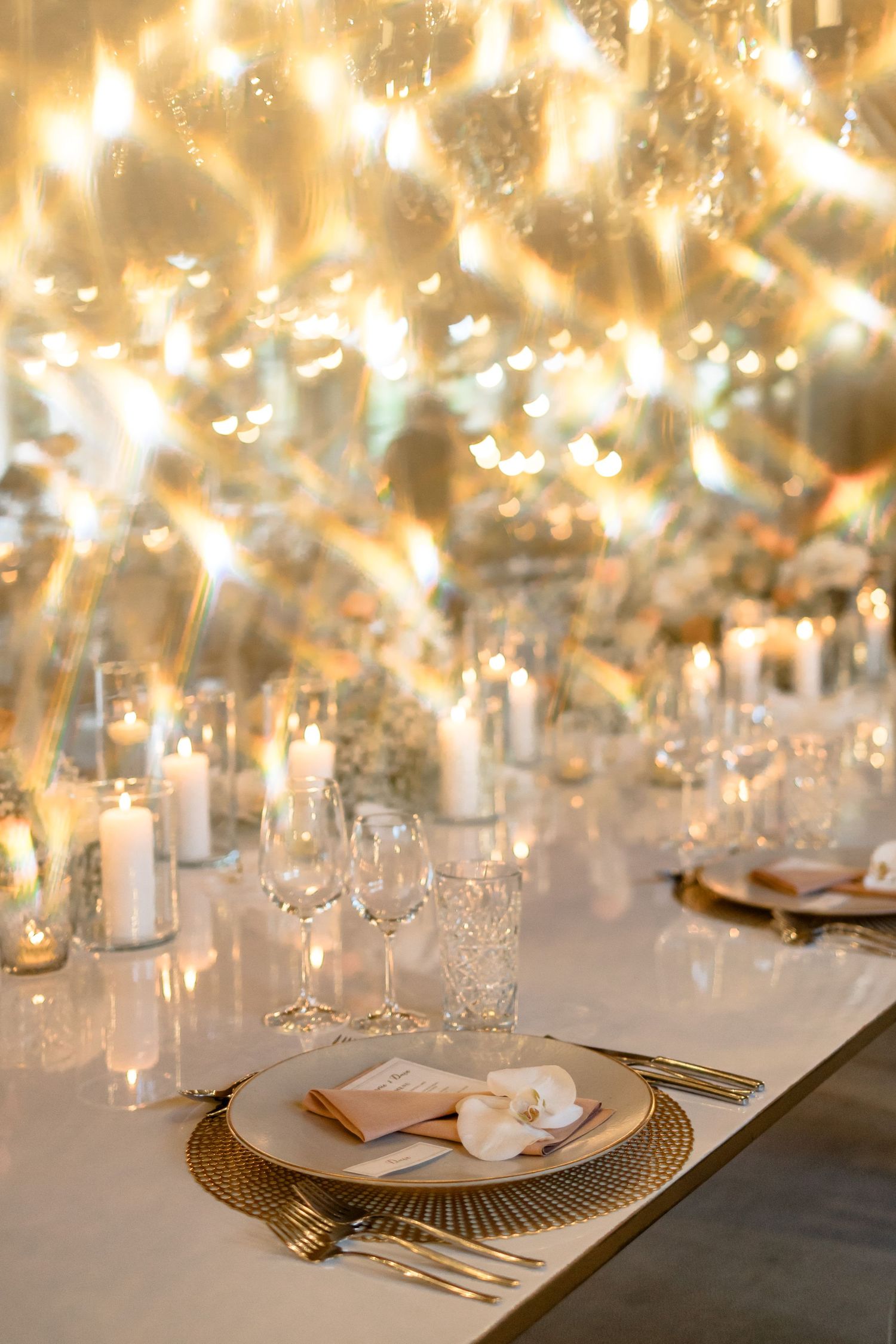 Luxurious table setting with sparkling chandeliers and candlelight creating a magical atmosphere.