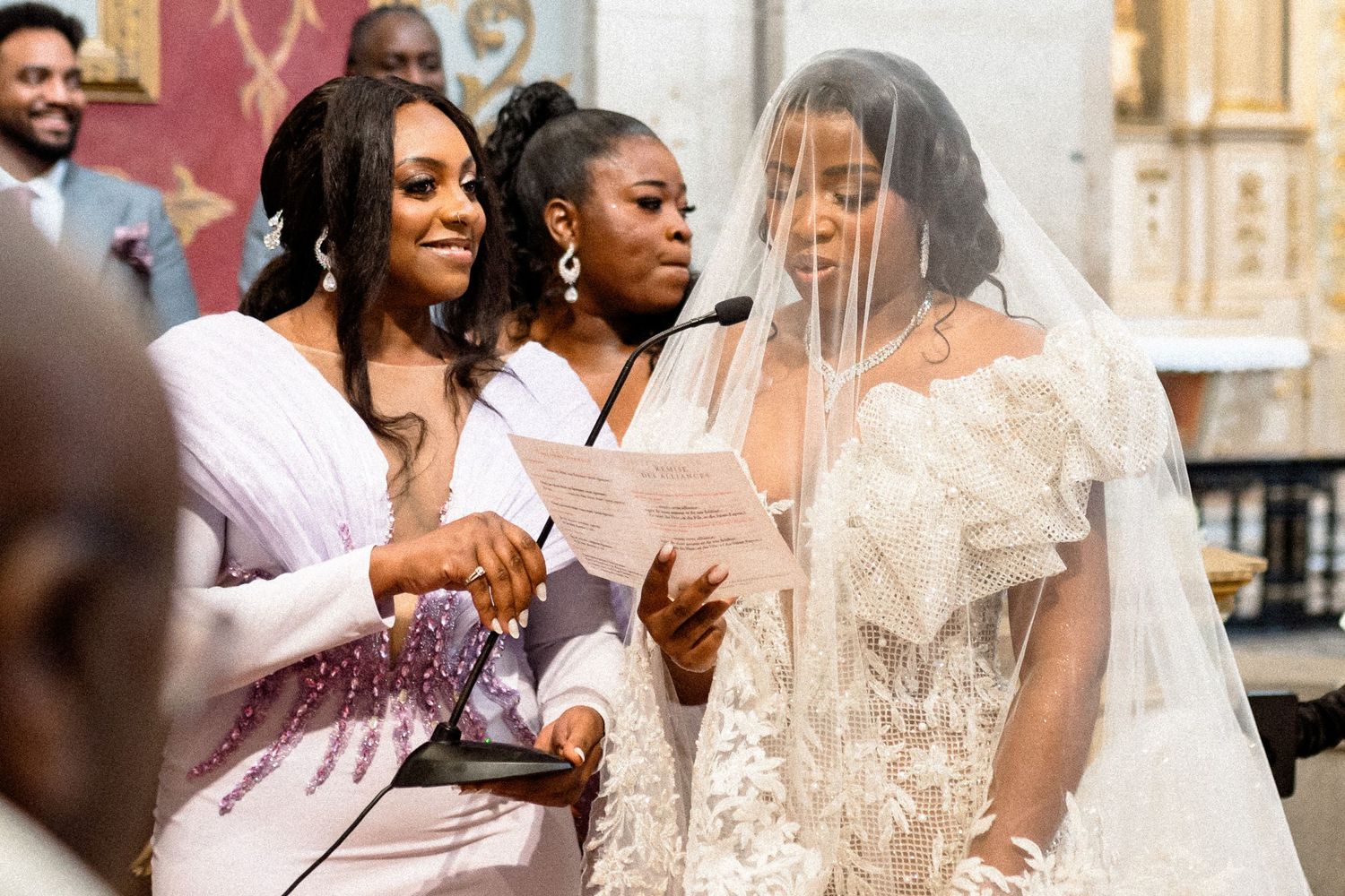 Wedding guests celebrate joyfully during an outdoor ceremony with elegant decor and floral arrangements.
