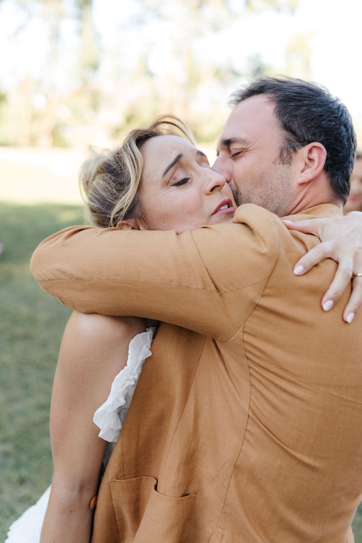 A tender embrace between a couple during their wedding celebration.