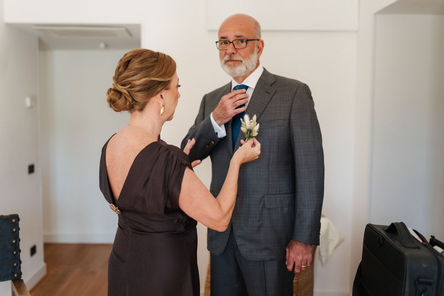 Wedding day first look moment between family members in formal attire.