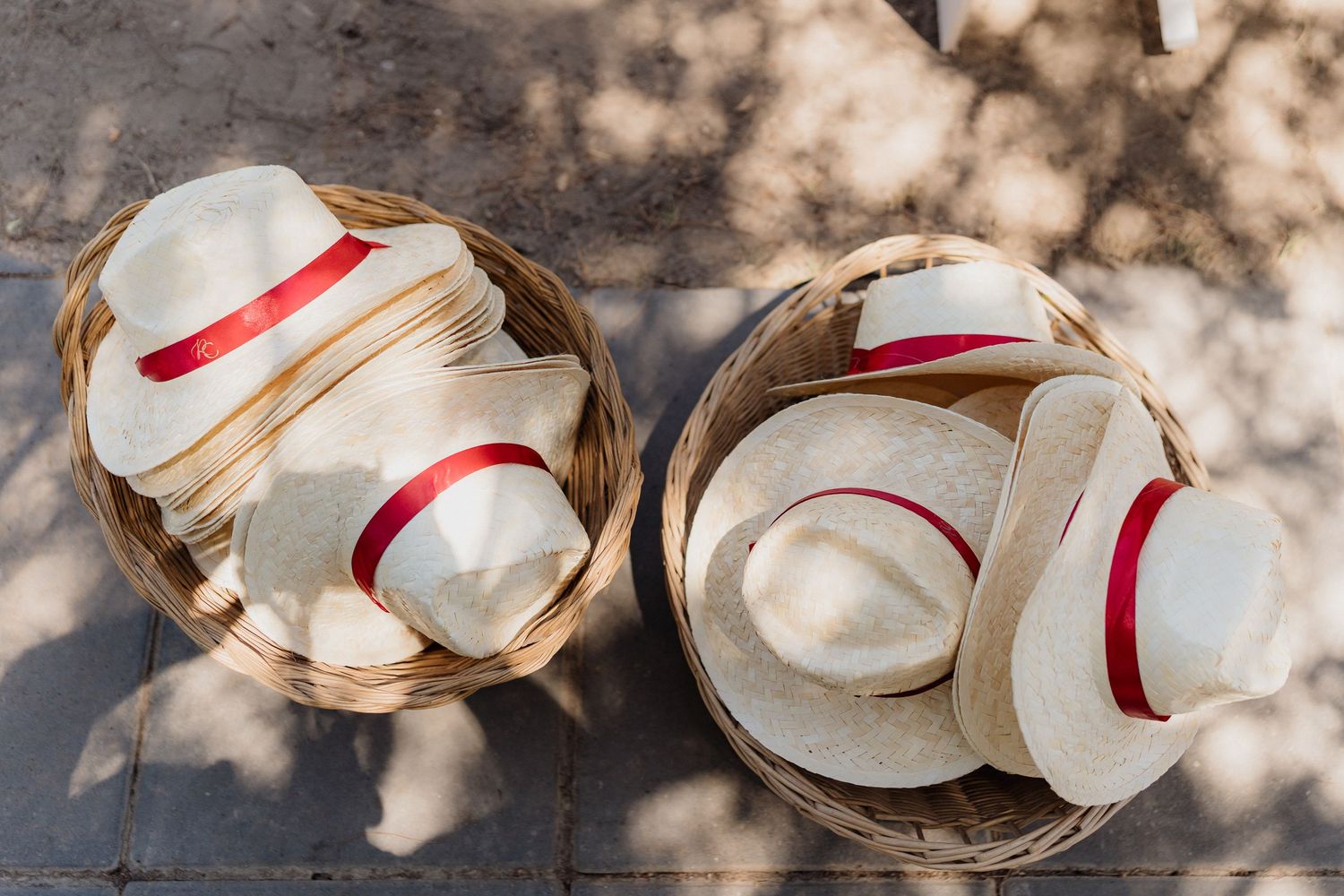 White wedding shoes with red ribbons arranged in an artistic pattern.