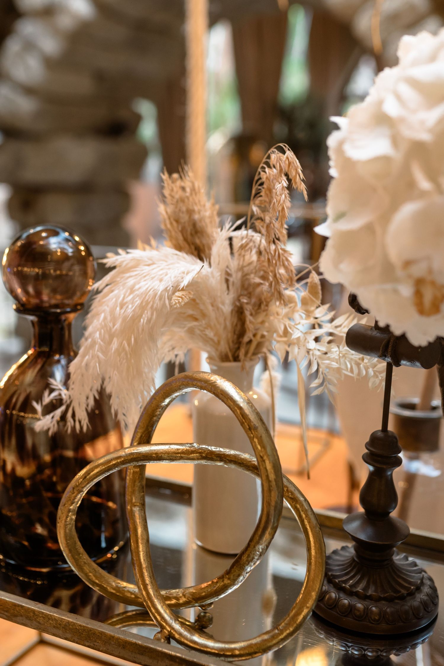 Vintage-style gold mirrors and decorative elements arranged on a wedding reception table.