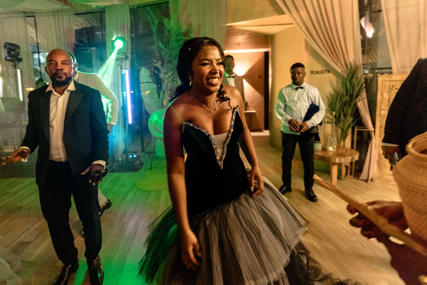 Wedding reception party scenes with colorful lighting and elegant decor.