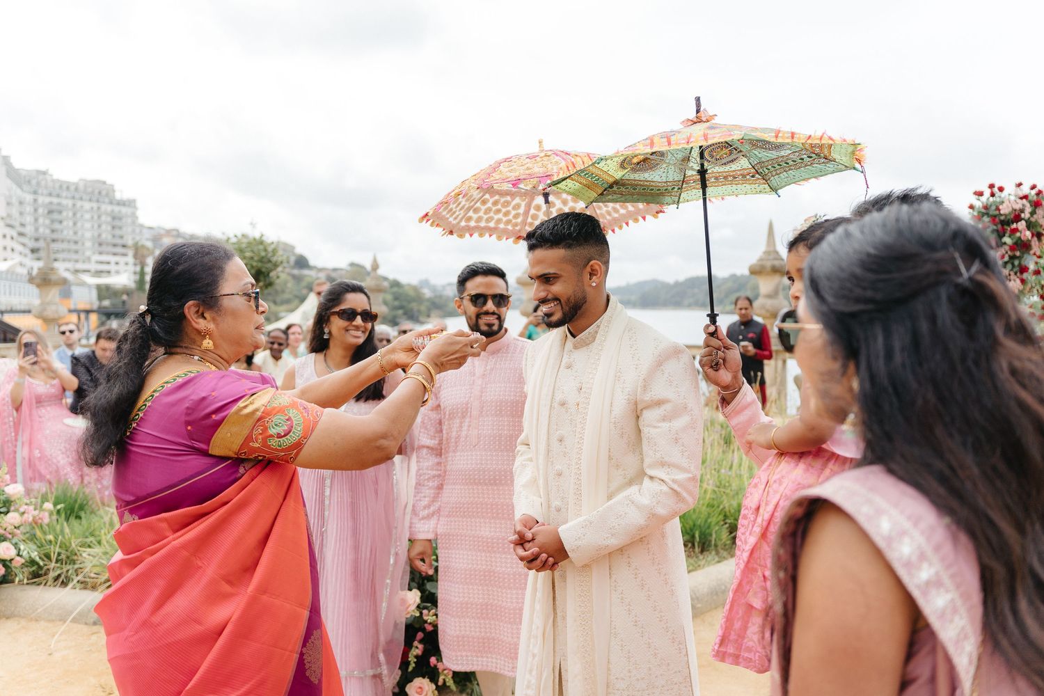 Wedding party celebrating outdoors with pink and red color scheme.