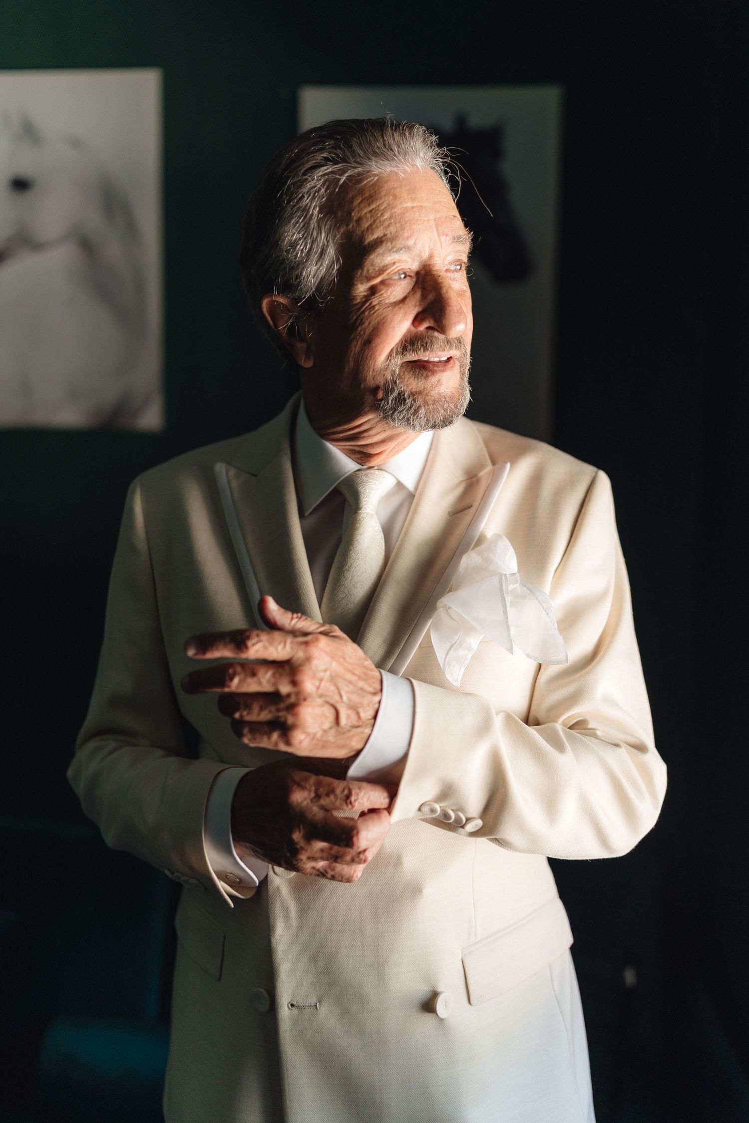 Dramatic sequence showing a person in a white suit gesturing emotively against a dark background.