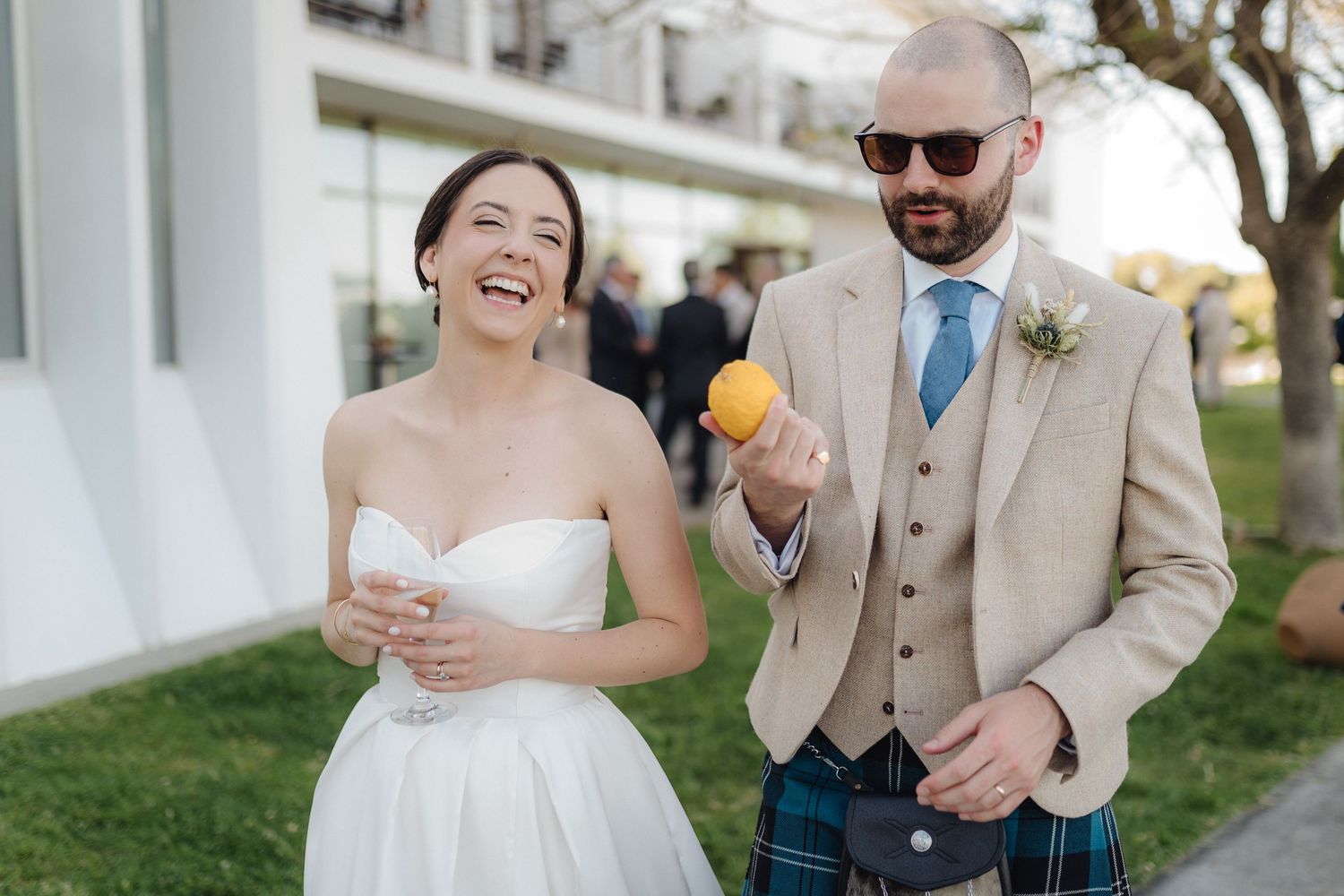 Wedding celebration moment in outdoor setting with bright natural lighting.