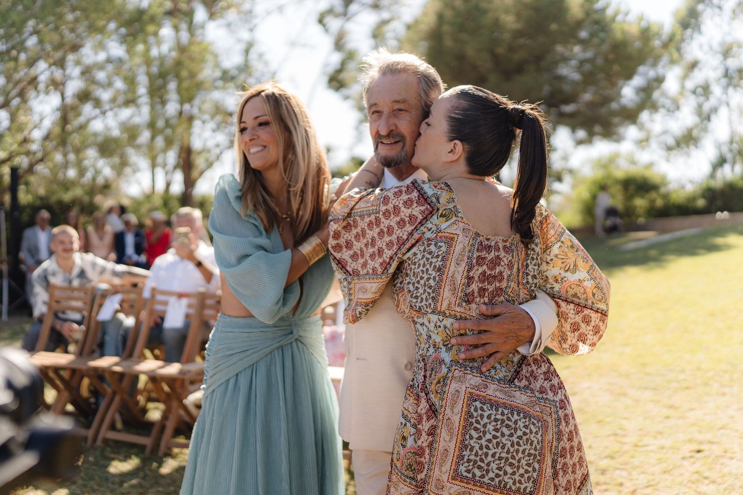 Guests share joyful moments during an outdoor wedding celebration.