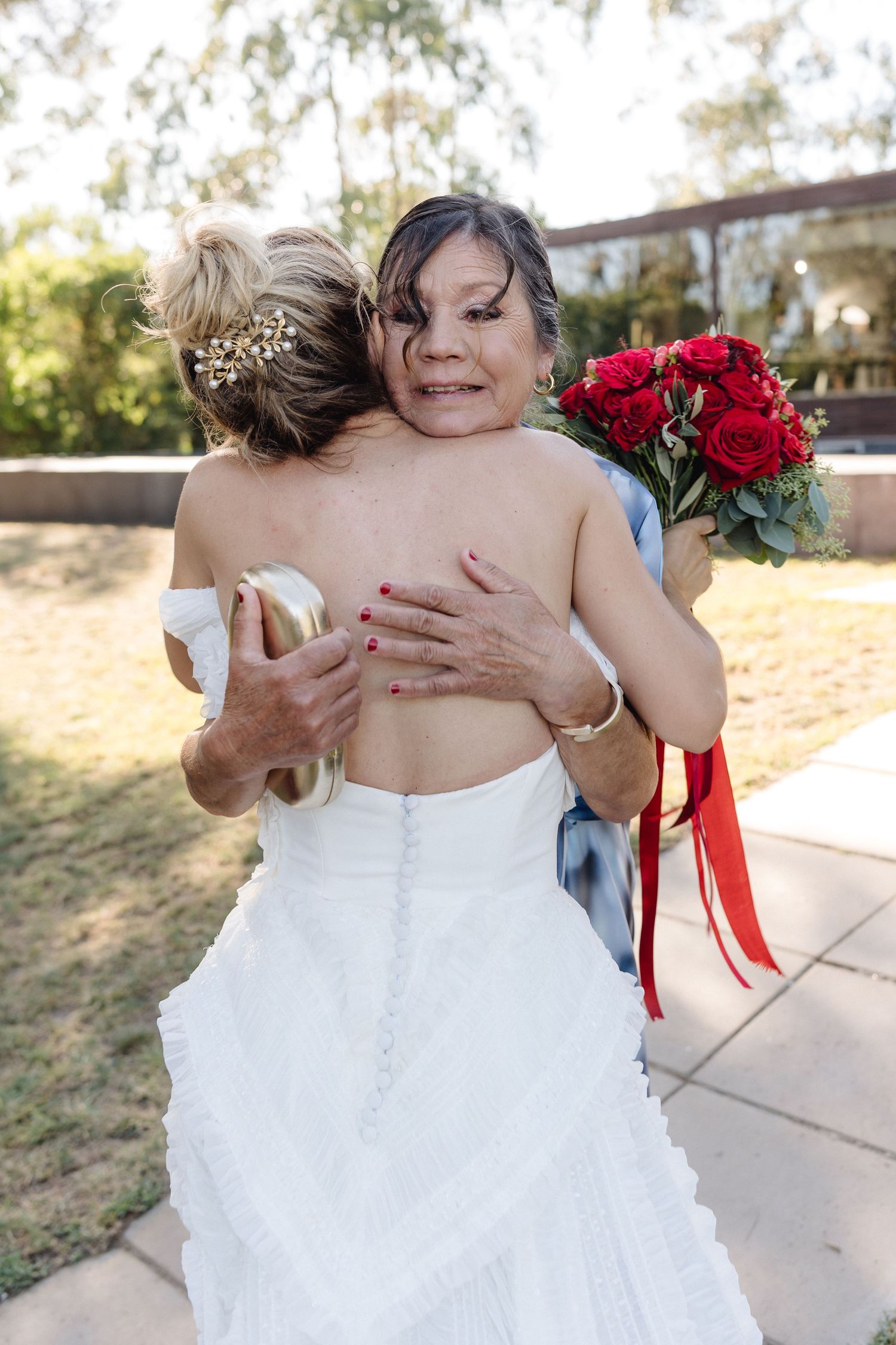 Emotional wedding moments captured through intimate embraces and white dress details.