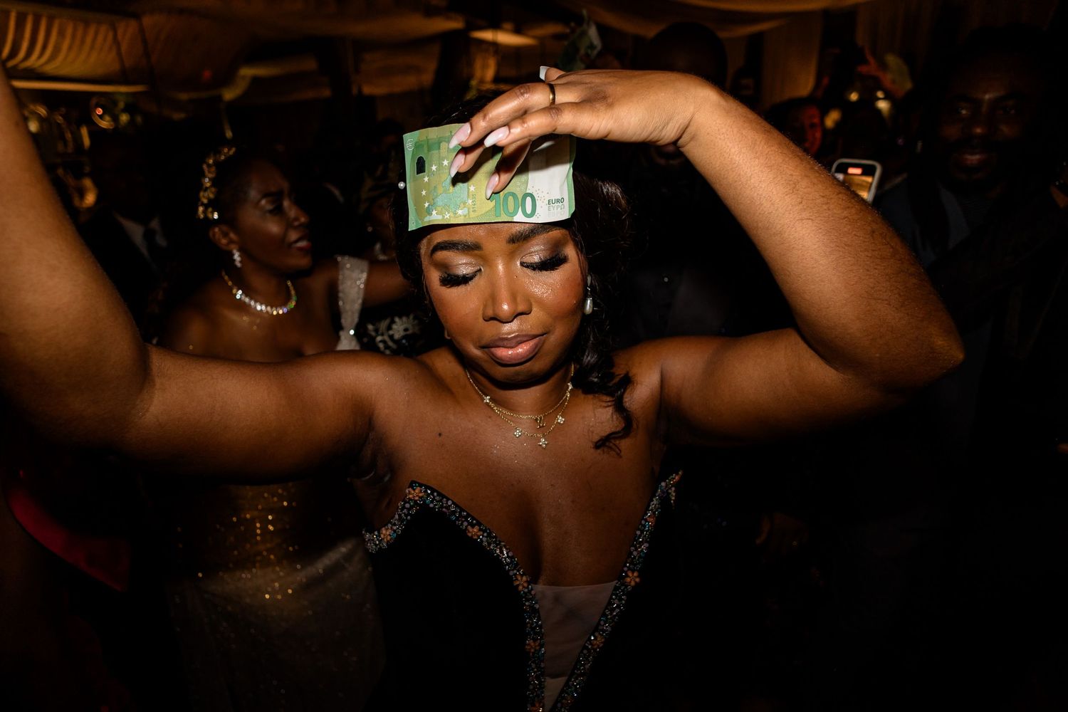 Artistic low-light photos capturing dancers and performers at a nighttime celebration.