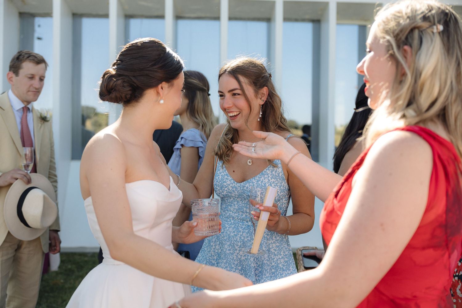 Wedding guests mingling and celebrating at an outdoor reception.