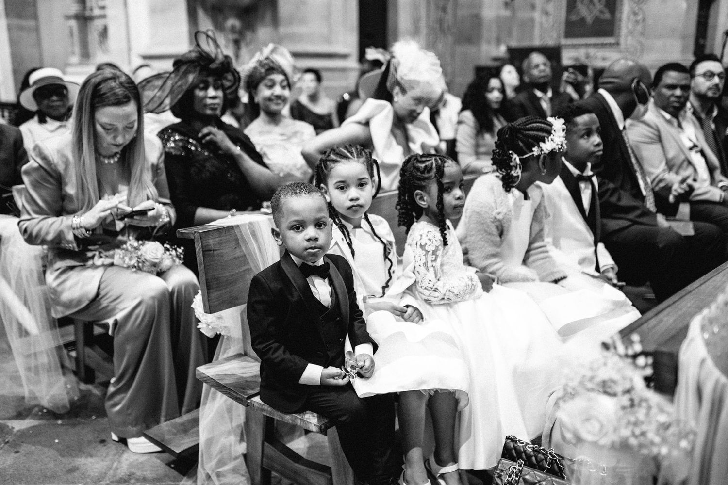 Wedding guests seated in church pews during a ceremony.