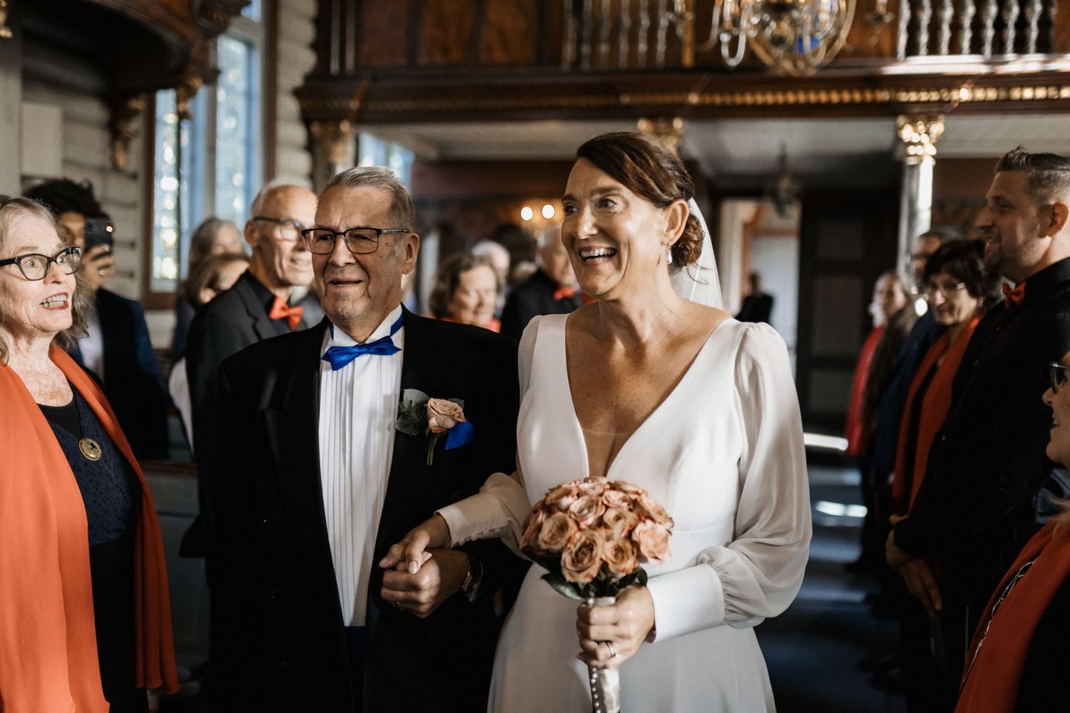 Elegant wedding reception in a grand hall with ornate architectural details.