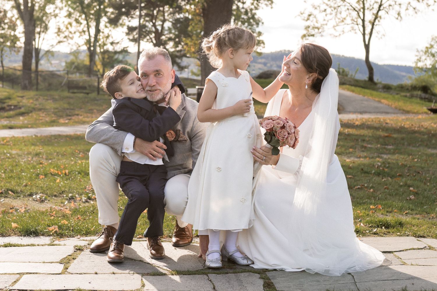 A joyful wedding party moment captured in golden sunlight on an autumn day.