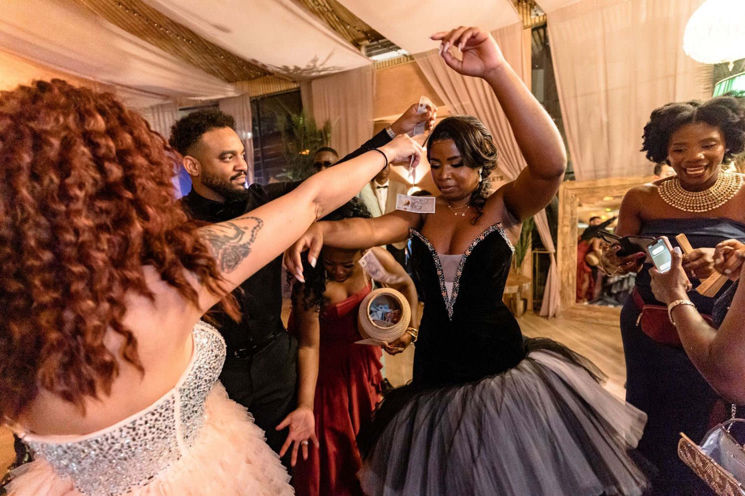 Wedding guests dancing and having fun during an animated reception celebration.