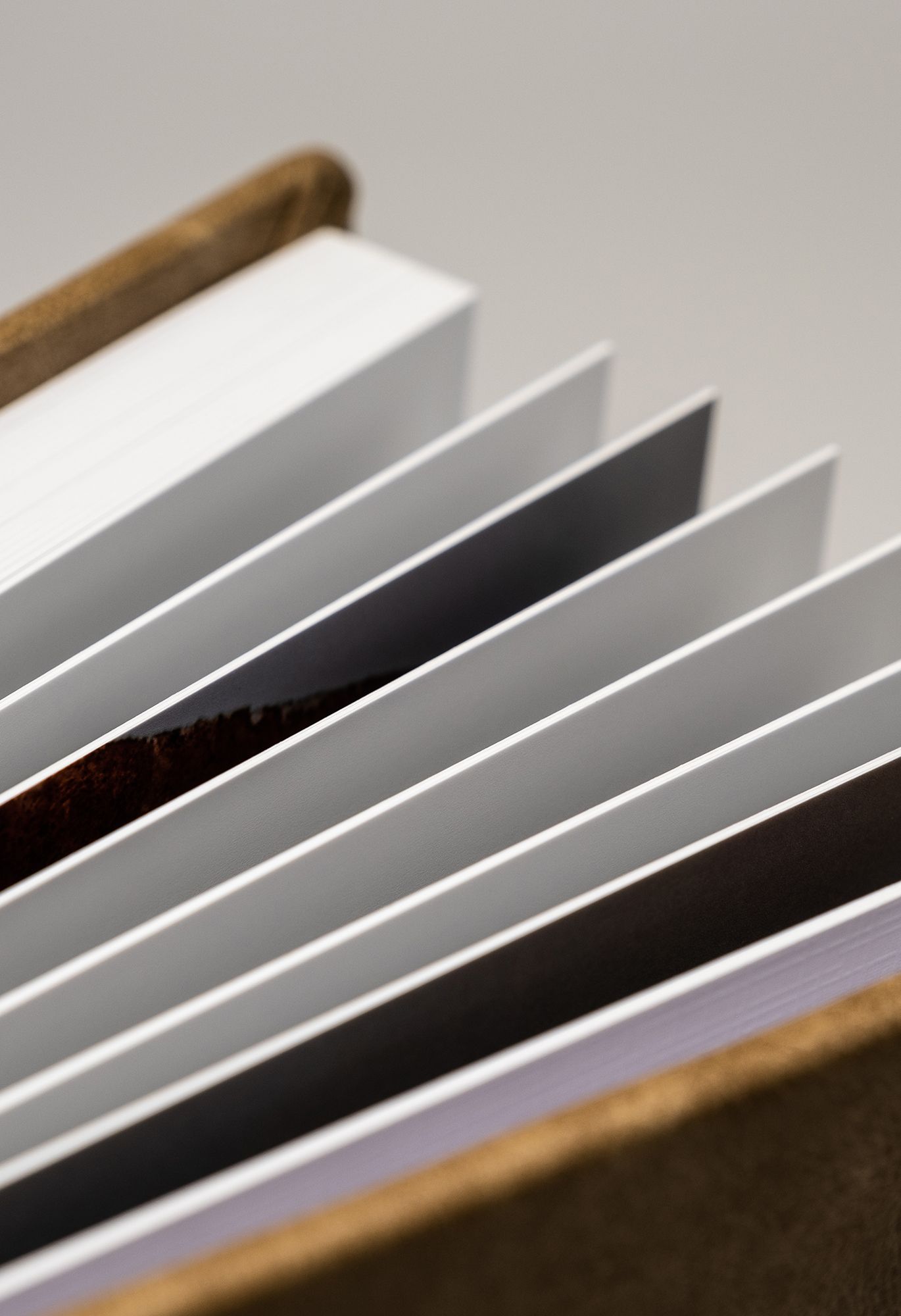 Abstract diagonal lines create a minimalist pattern with alternating white and dark stripes against a wooden frame.