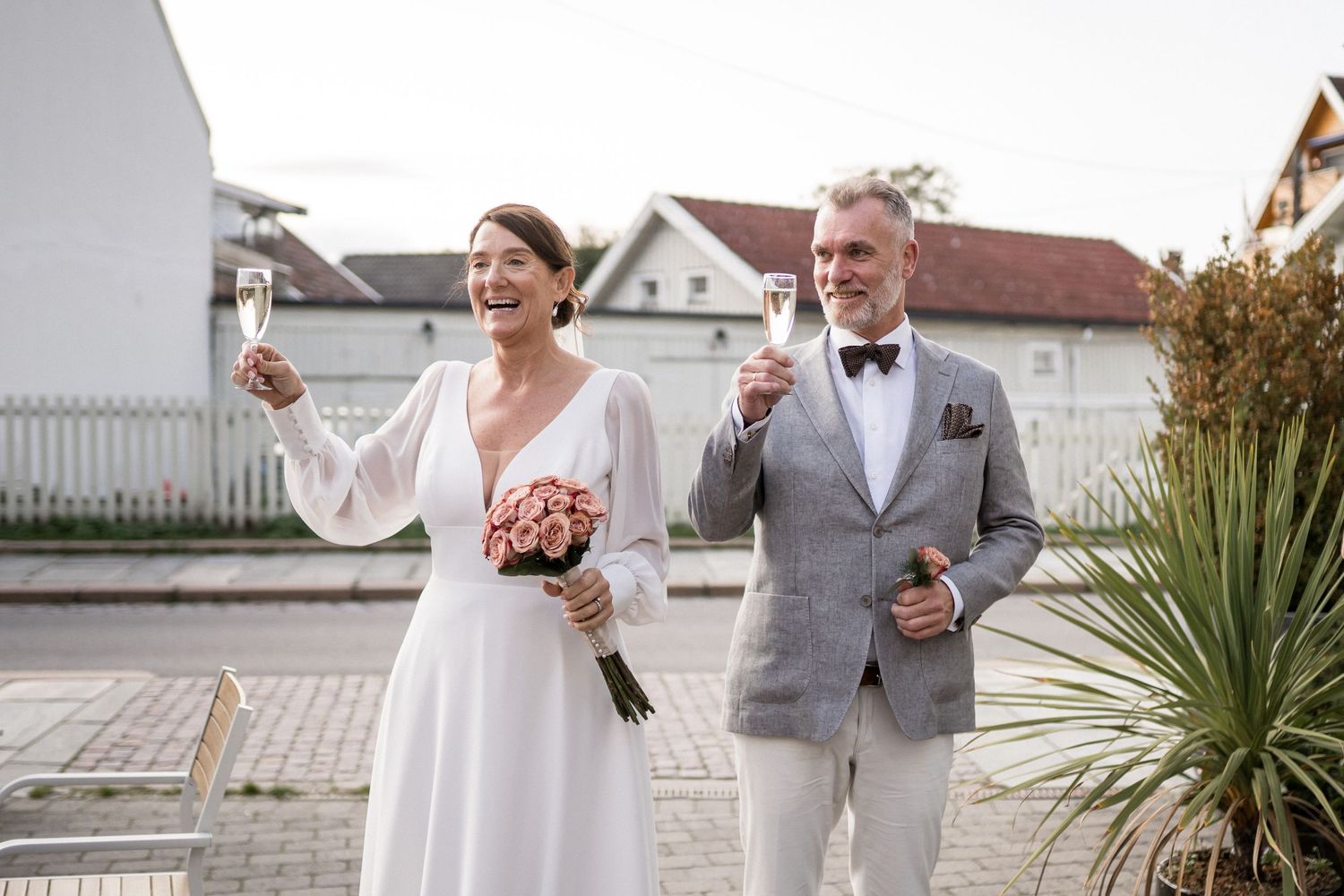 Joyful wedding celebration moments captured outside with natural lighting.