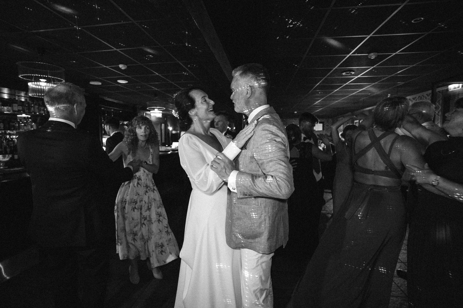 Black and white photo of couples dancing at a wedding reception.