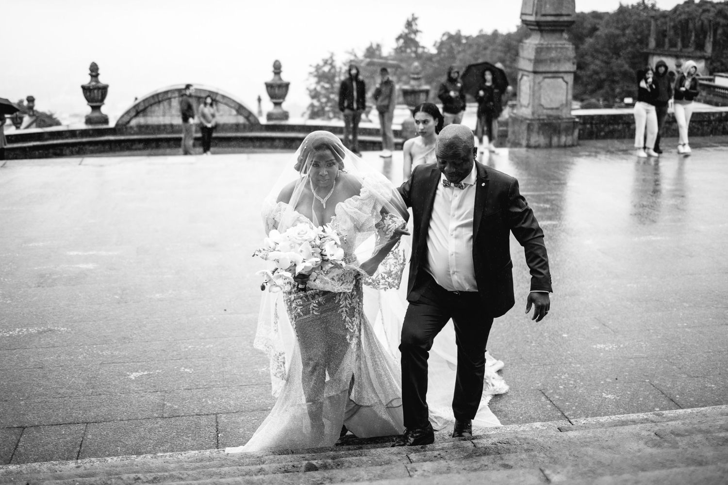 Black and white wedding photos showing movement and celebration outdoors.