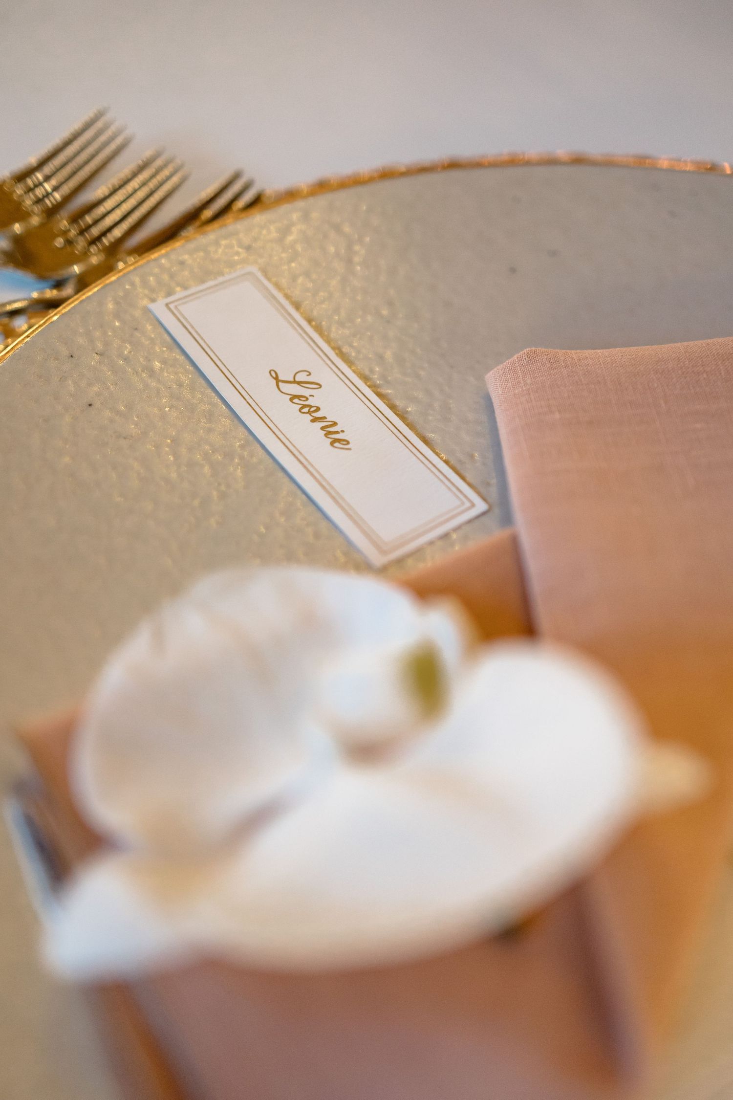 Close-up of minimalist wedding place cards and table settings in soft tones.