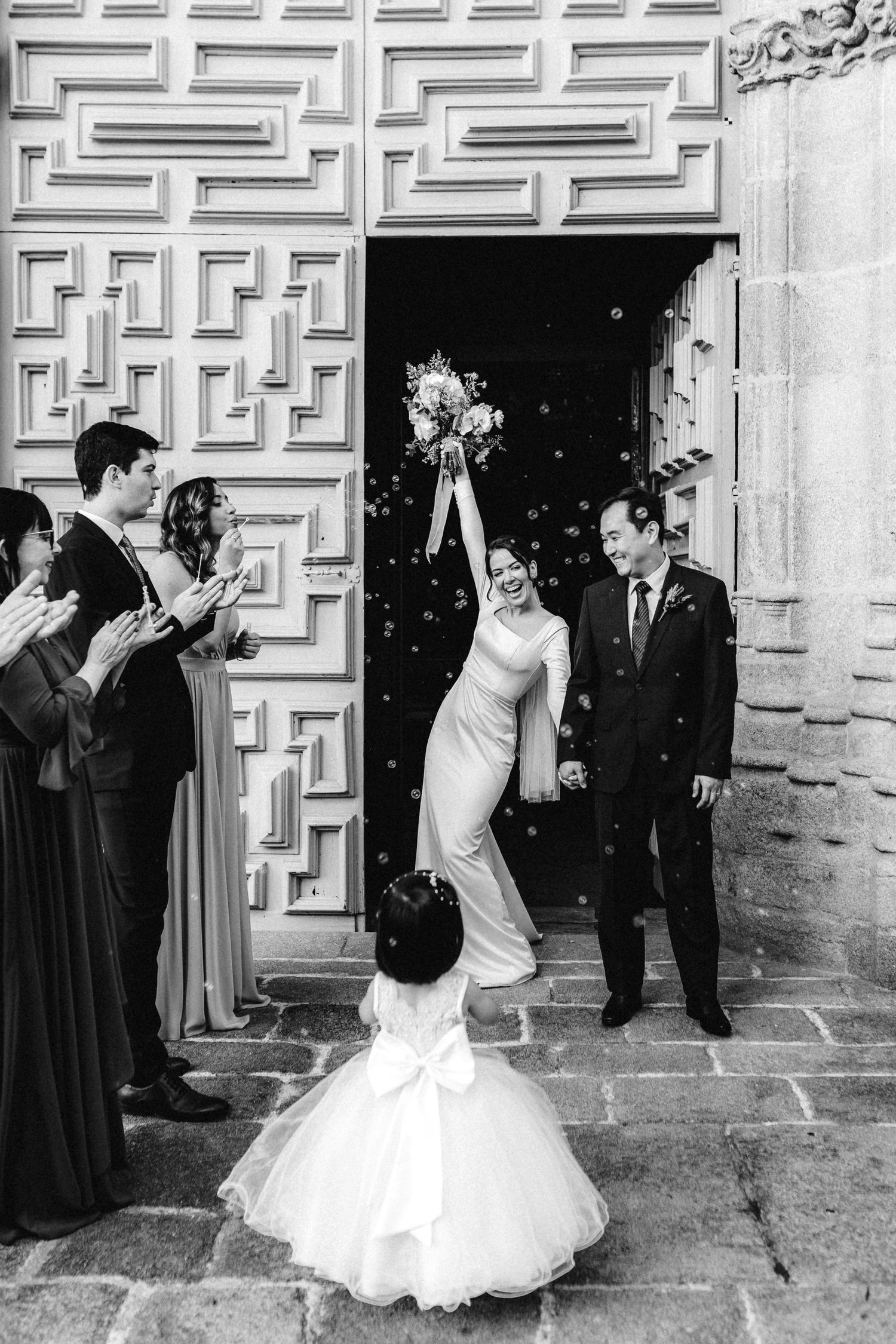 Black and white sequence of wedding celebration moments outside a church with decorative stone walls.