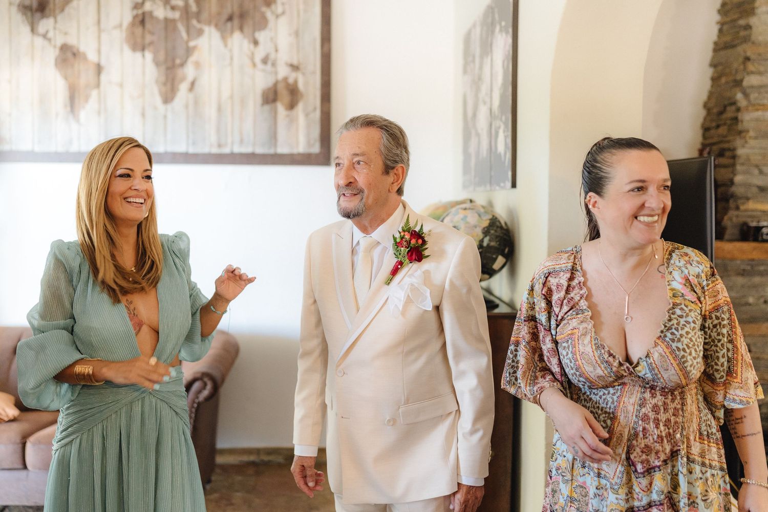 People interacting and laughing together in a room with rustic wood panel walls.