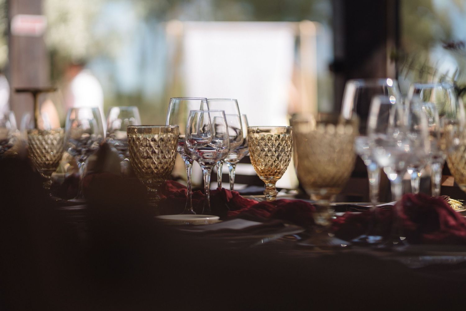 Romantic table settings with glowing candlelight and delicate glassware for an evening reception.