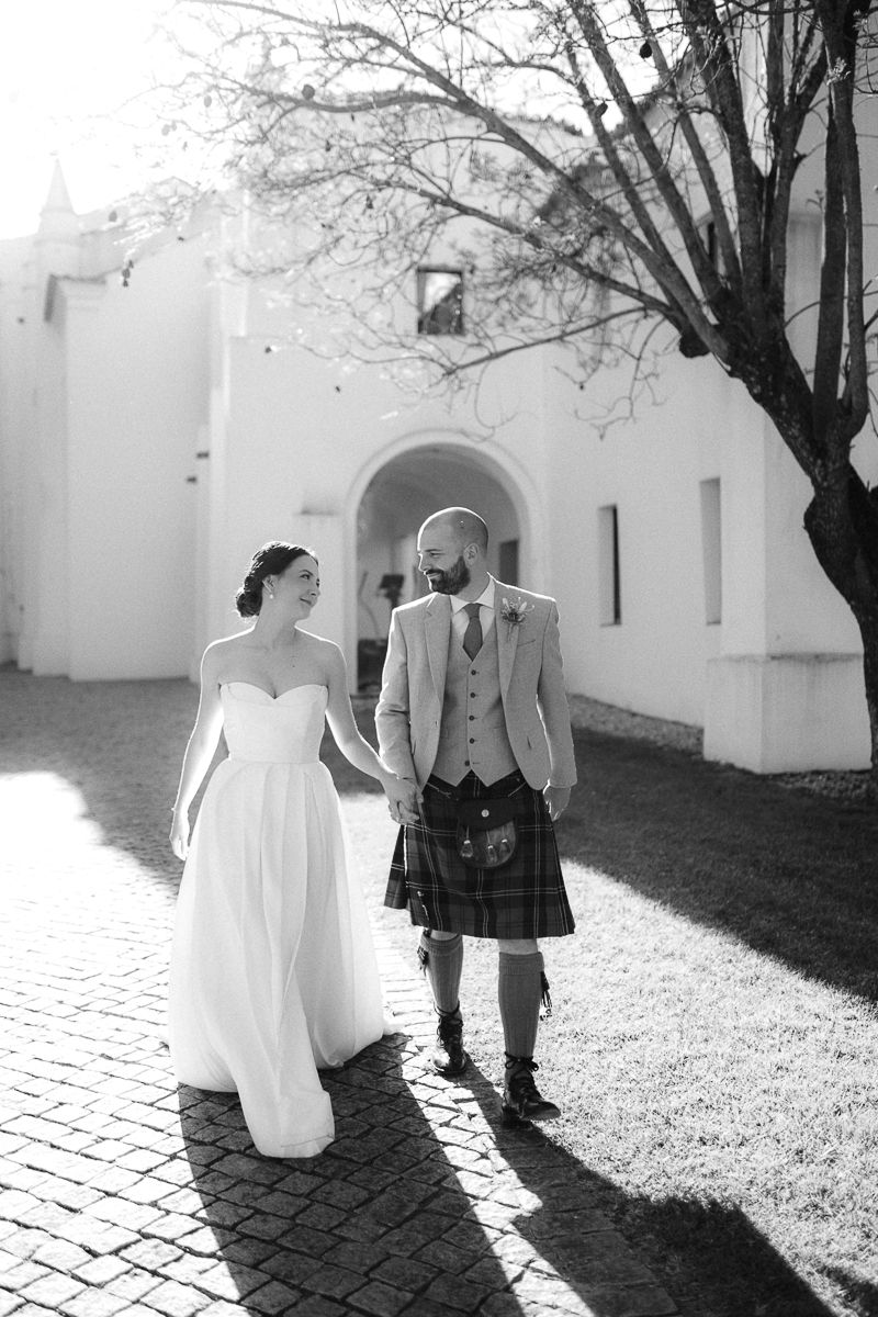 Black and white wedding photos showing a couple walking along a brick pathway.