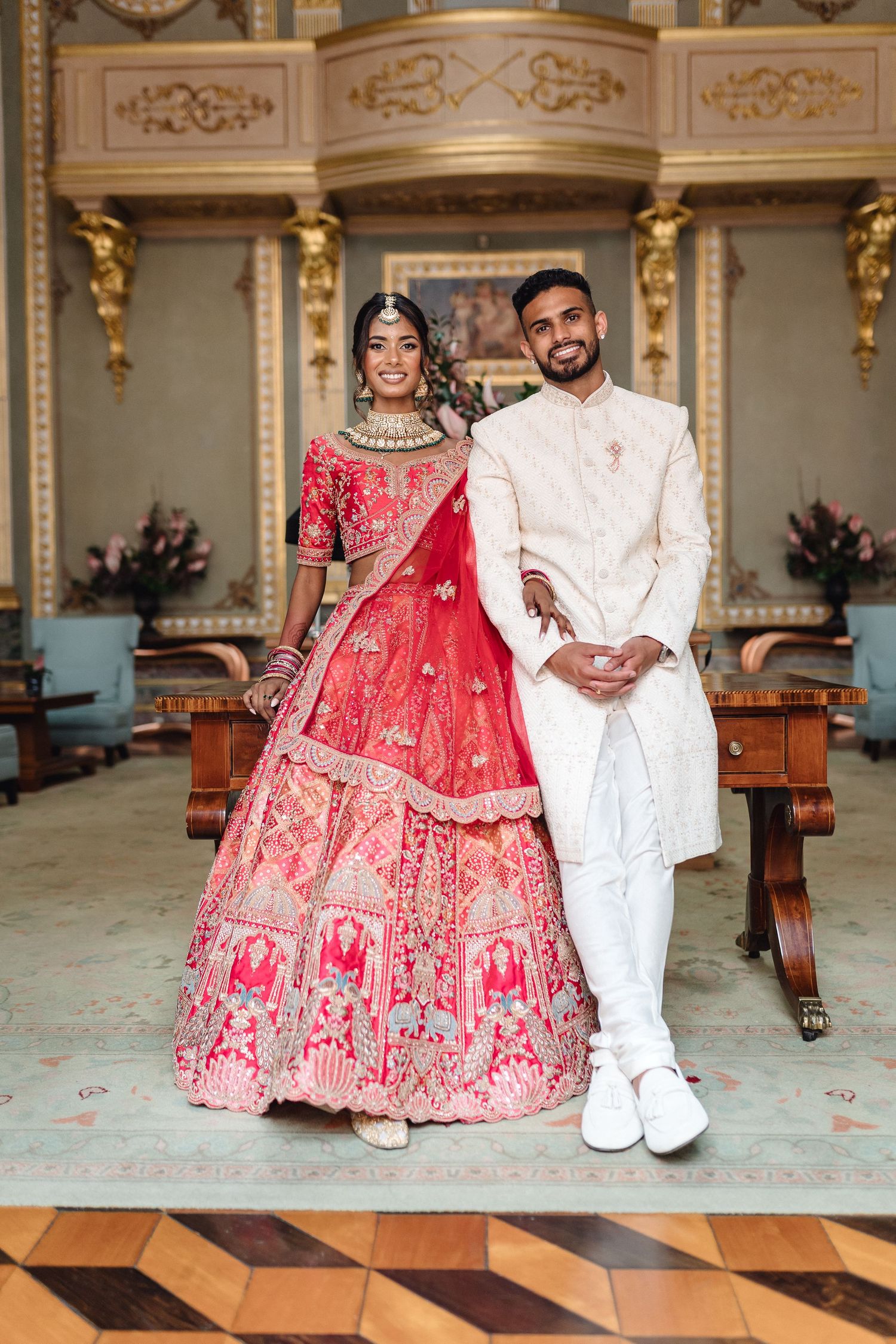 Elegant wedding portraits in ornate gold-detailed indoor venue.