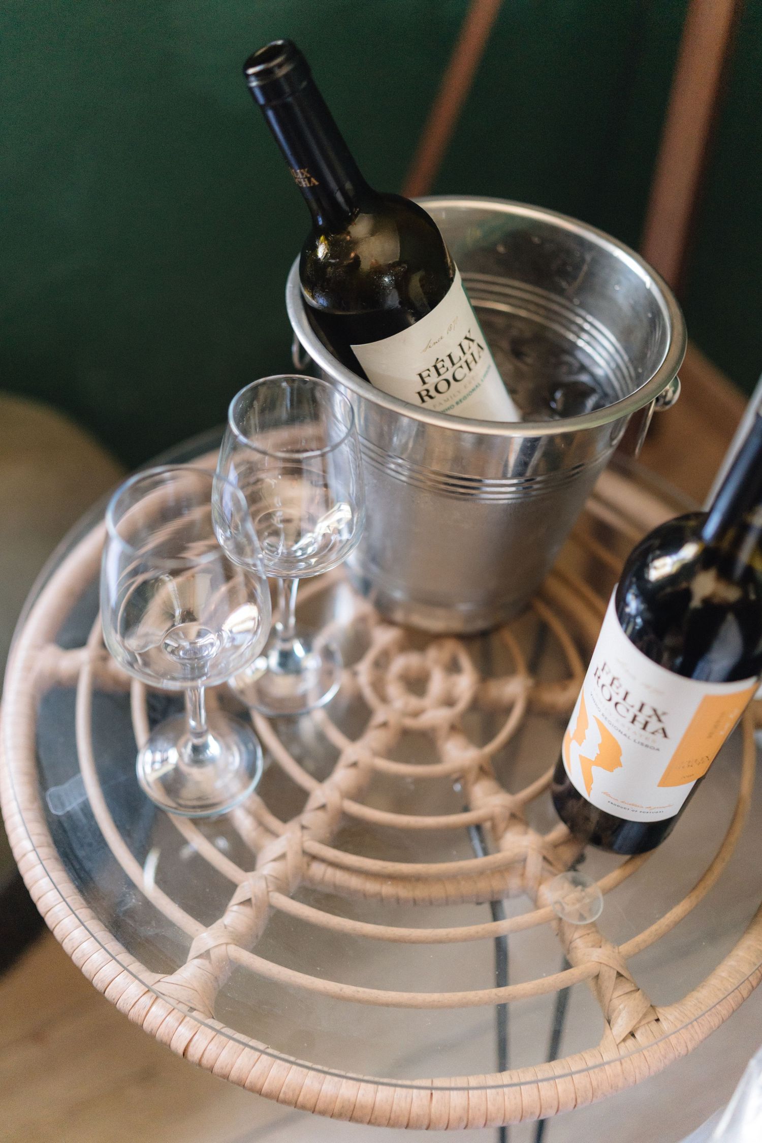 Wine bottles and glasses arranged on a silver tray with elegant presentation.