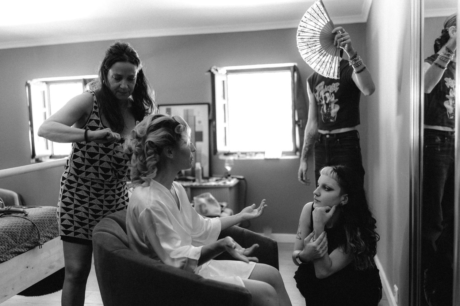 Behind the scenes preparation with styling tools and equipment visible.