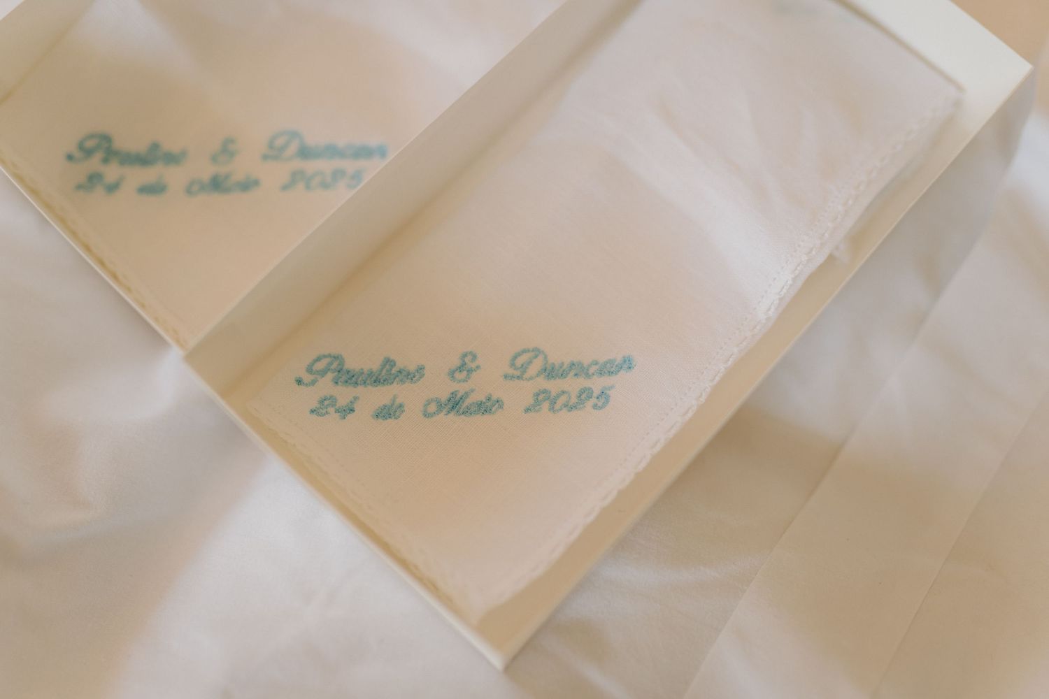 Delicate blue calligraphy text on white wedding invitation cards.