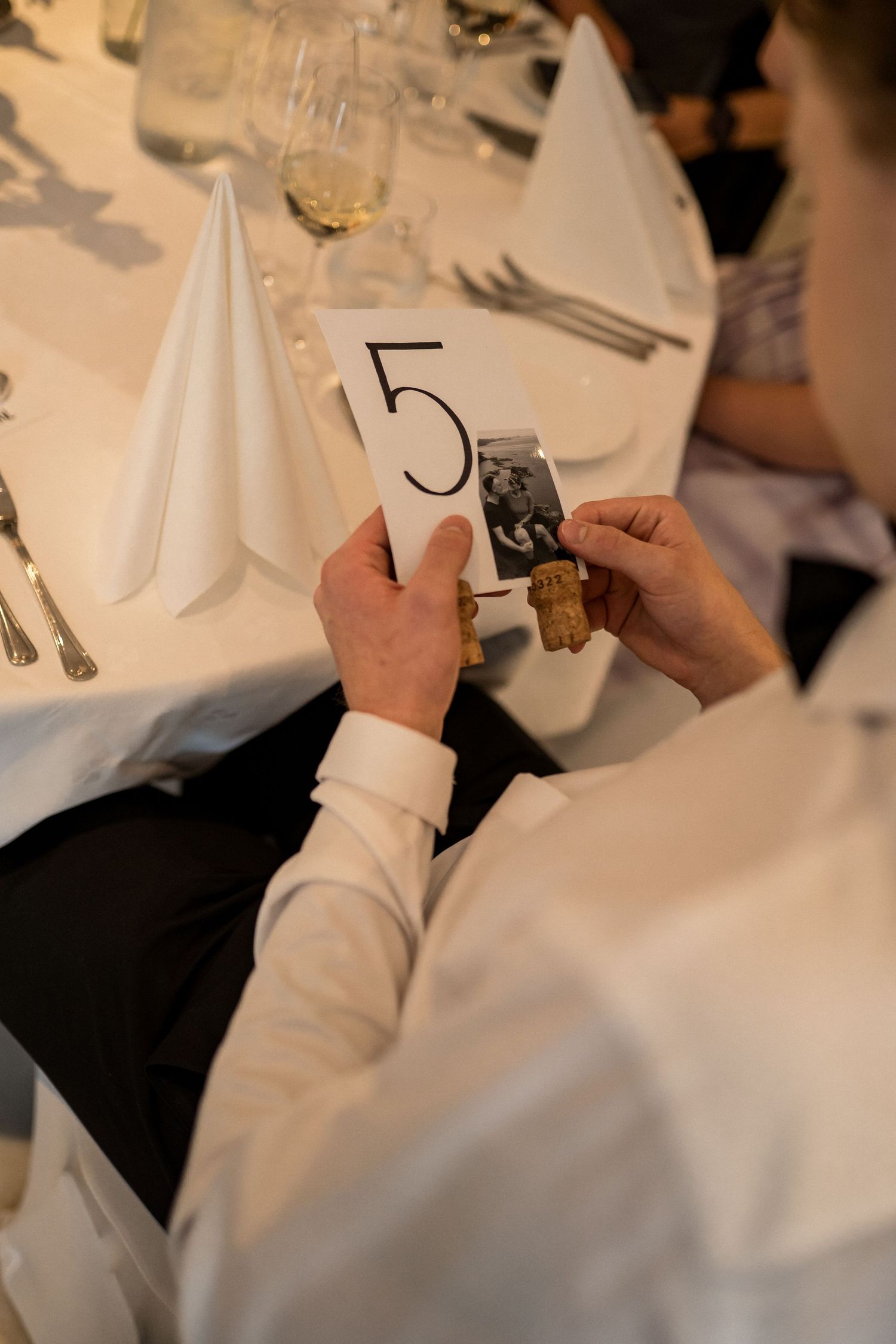 Close-up of white table settings and napkins at an elegant wedding reception.