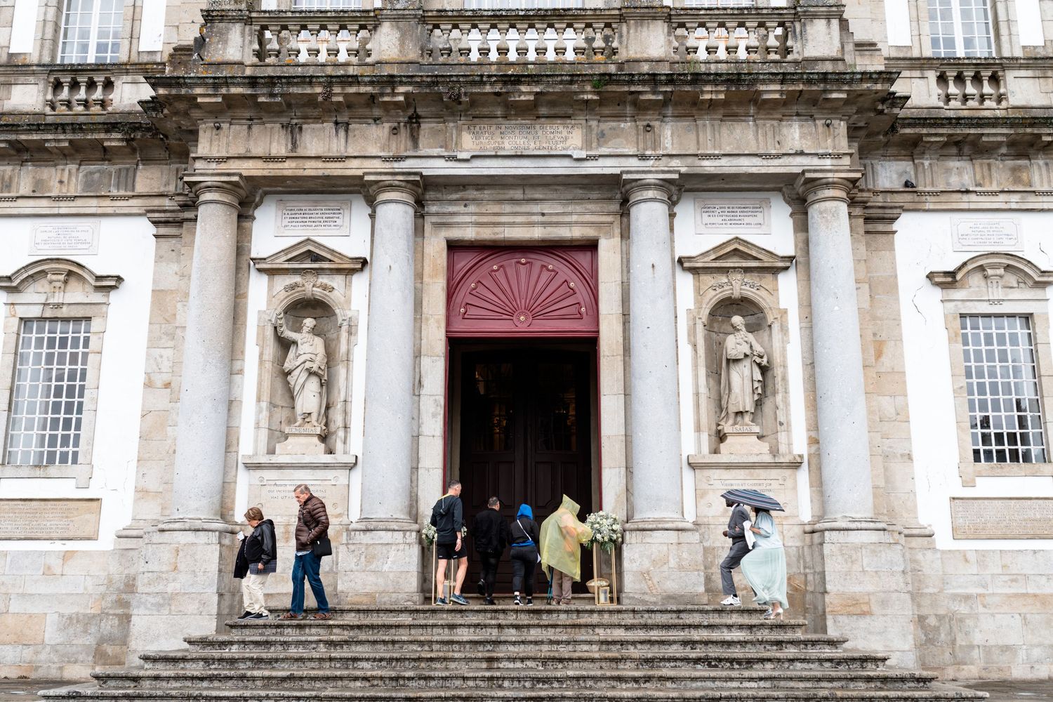 Historic stone church facade with ornate architectural details and balustrades.