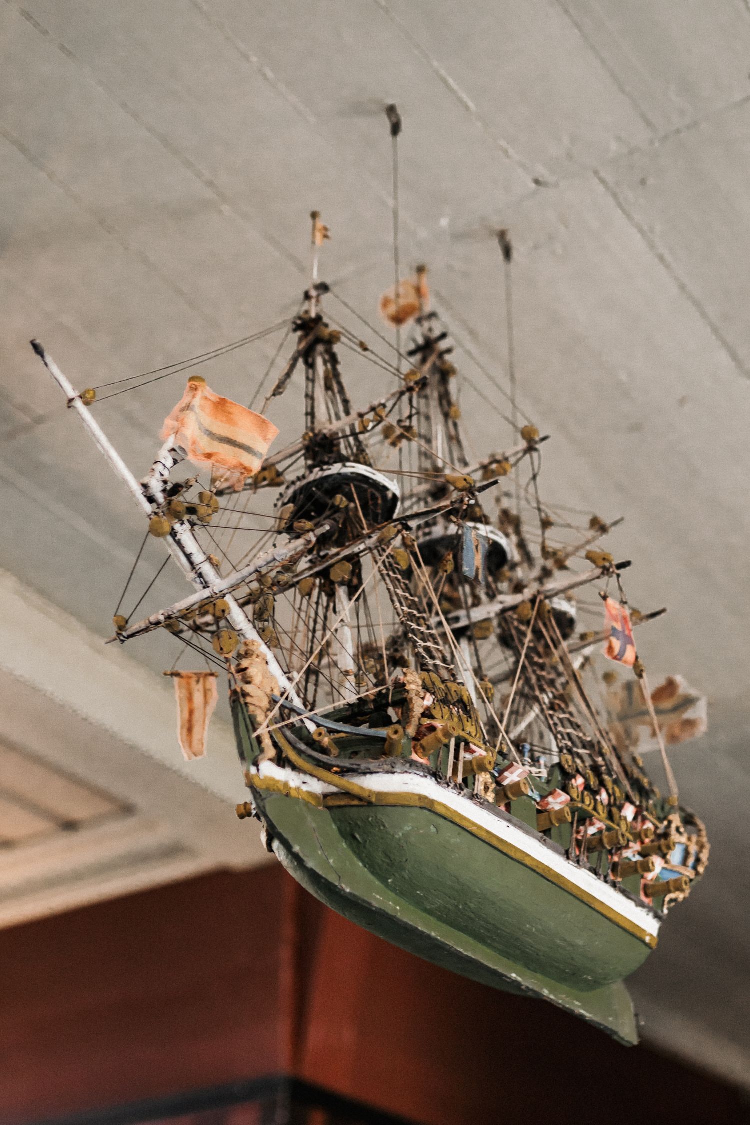Series of images showing a detailed model sailing ship suspended from the ceiling.