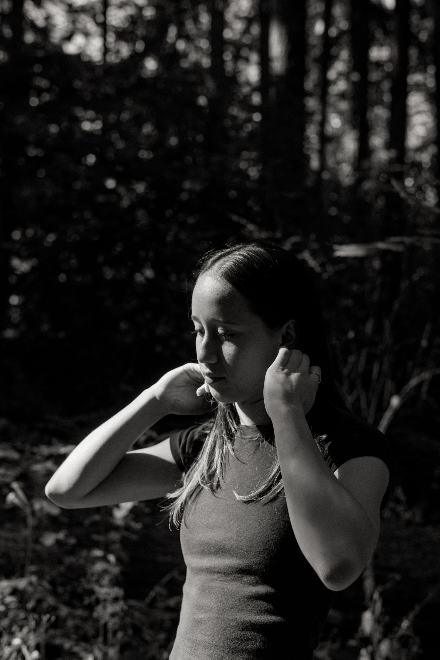 Black and white photo sequence showing a dancer performing fluid movements in a forest setting.