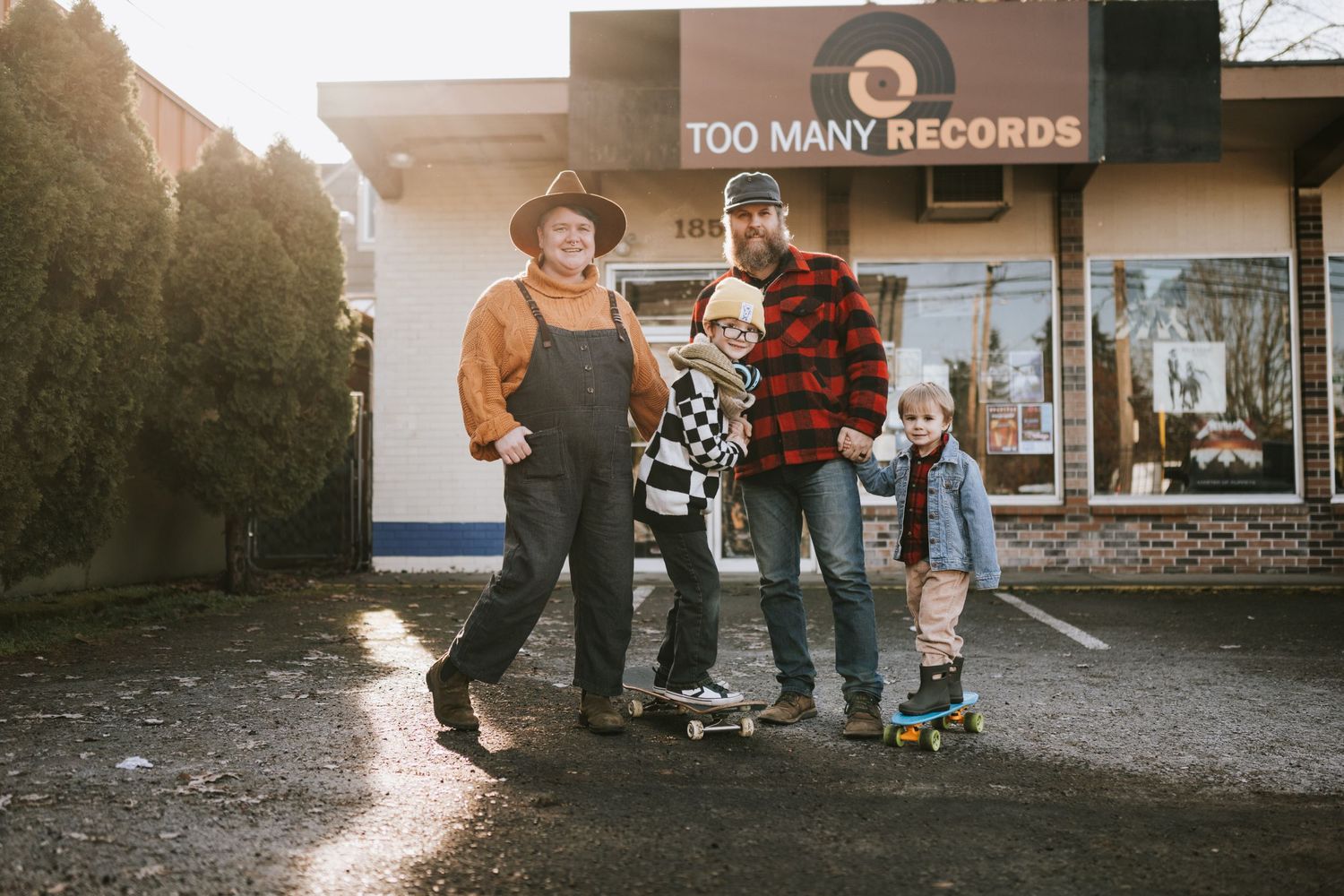 Group standing outside Too Many Records store with someone on rollerskates.