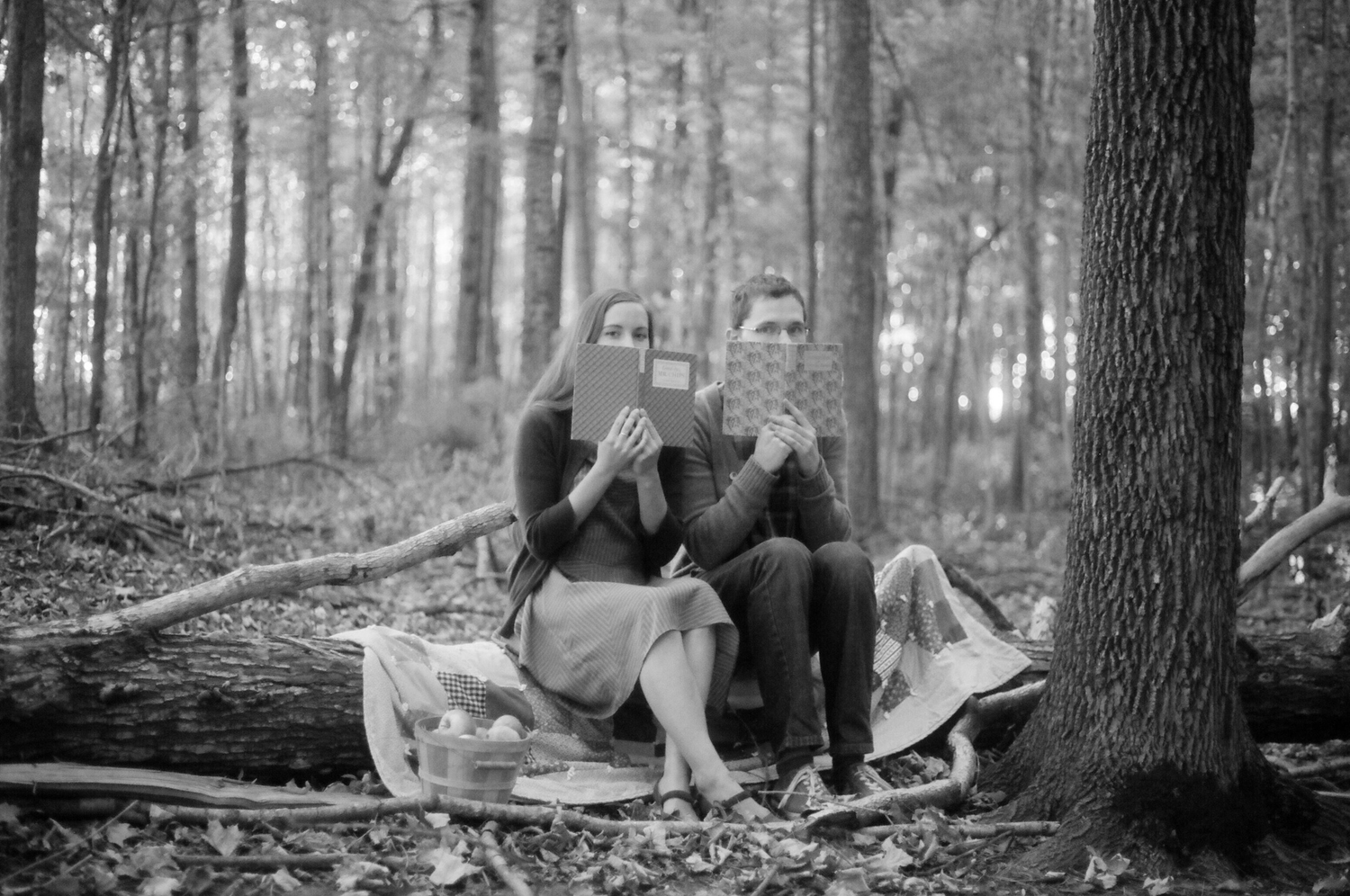 Black and white photos of people relaxing together in a peaceful forest setting.