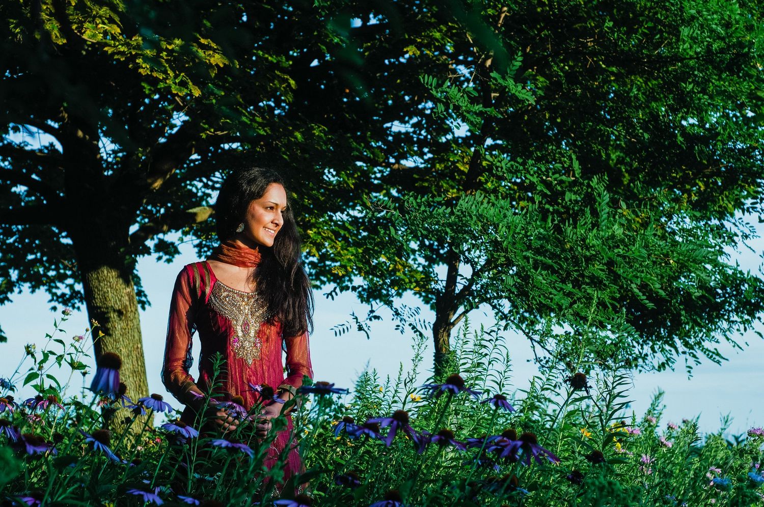 A dreamy portrait among bluebells and trees in natural lighting.