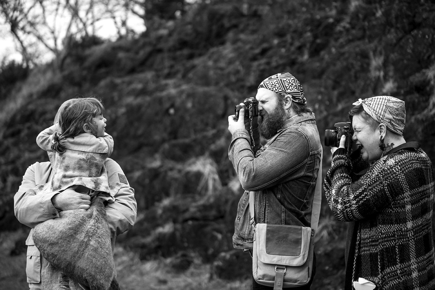 A series of black and white photos showing people looking through binoculars and telescopes outdoors.
