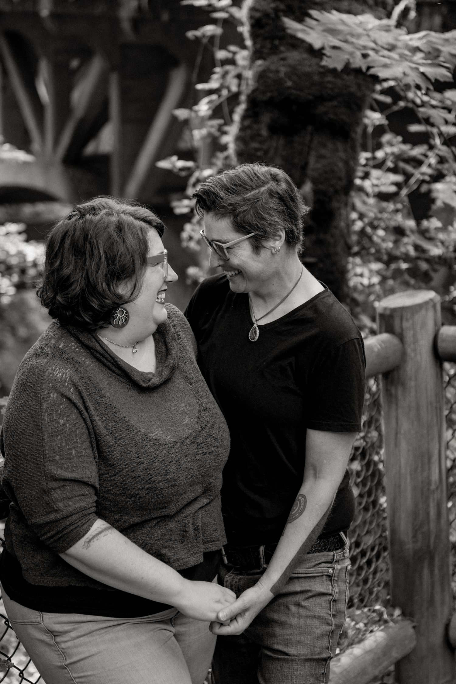 Black and white romantic photo sequence showing a couple laughing and embracing in a garden setting.