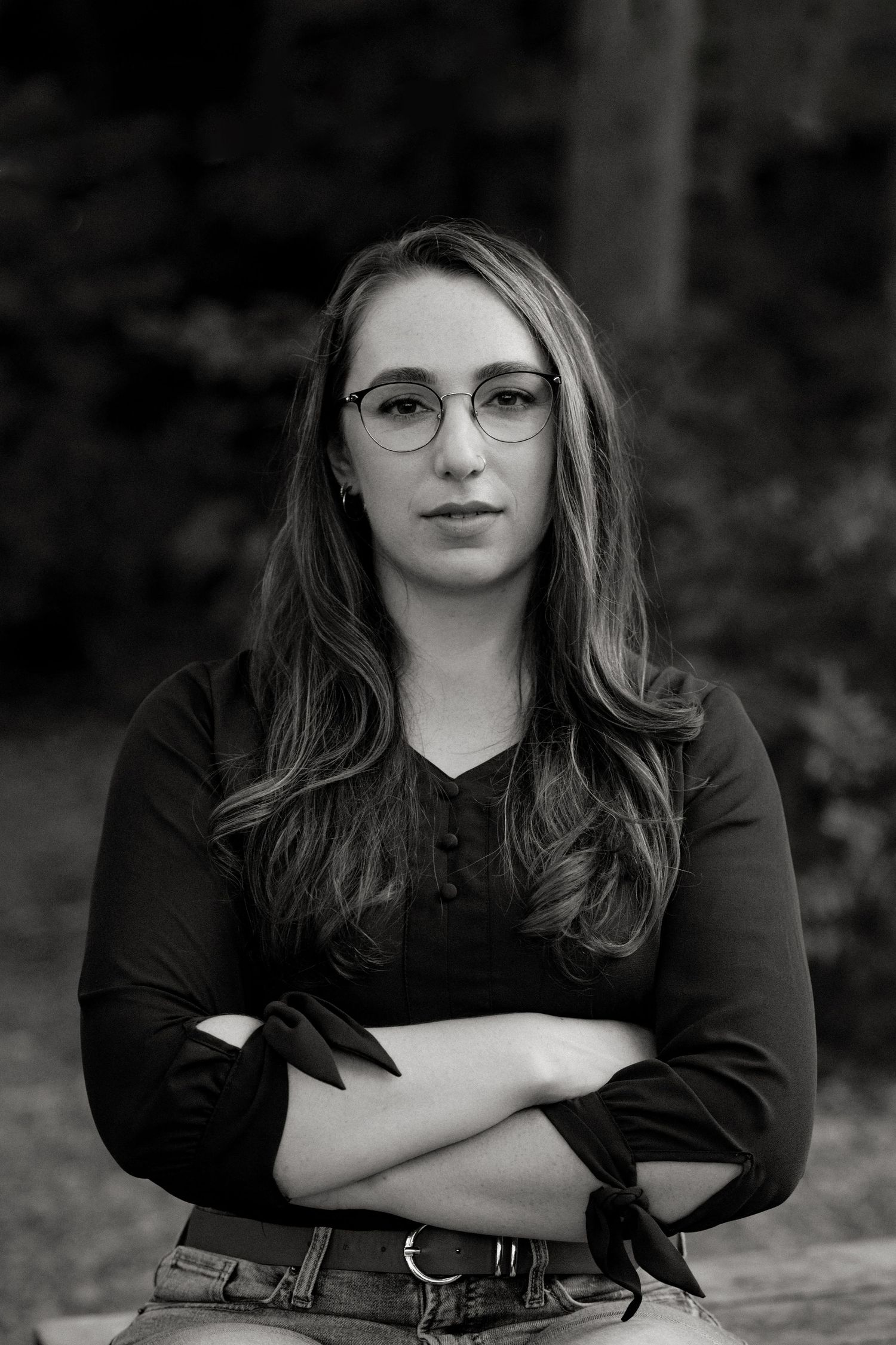 Black and white portrait series showing the same person in different poses against a dark background.