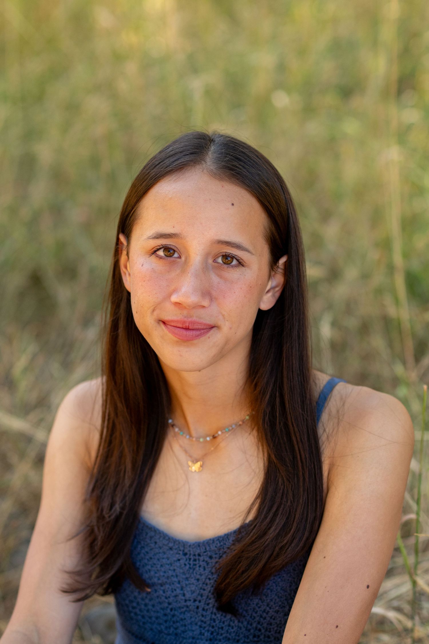 A series of close-up portraits showing a young woman in a navy top smiling outdoors against a natural backdrop.