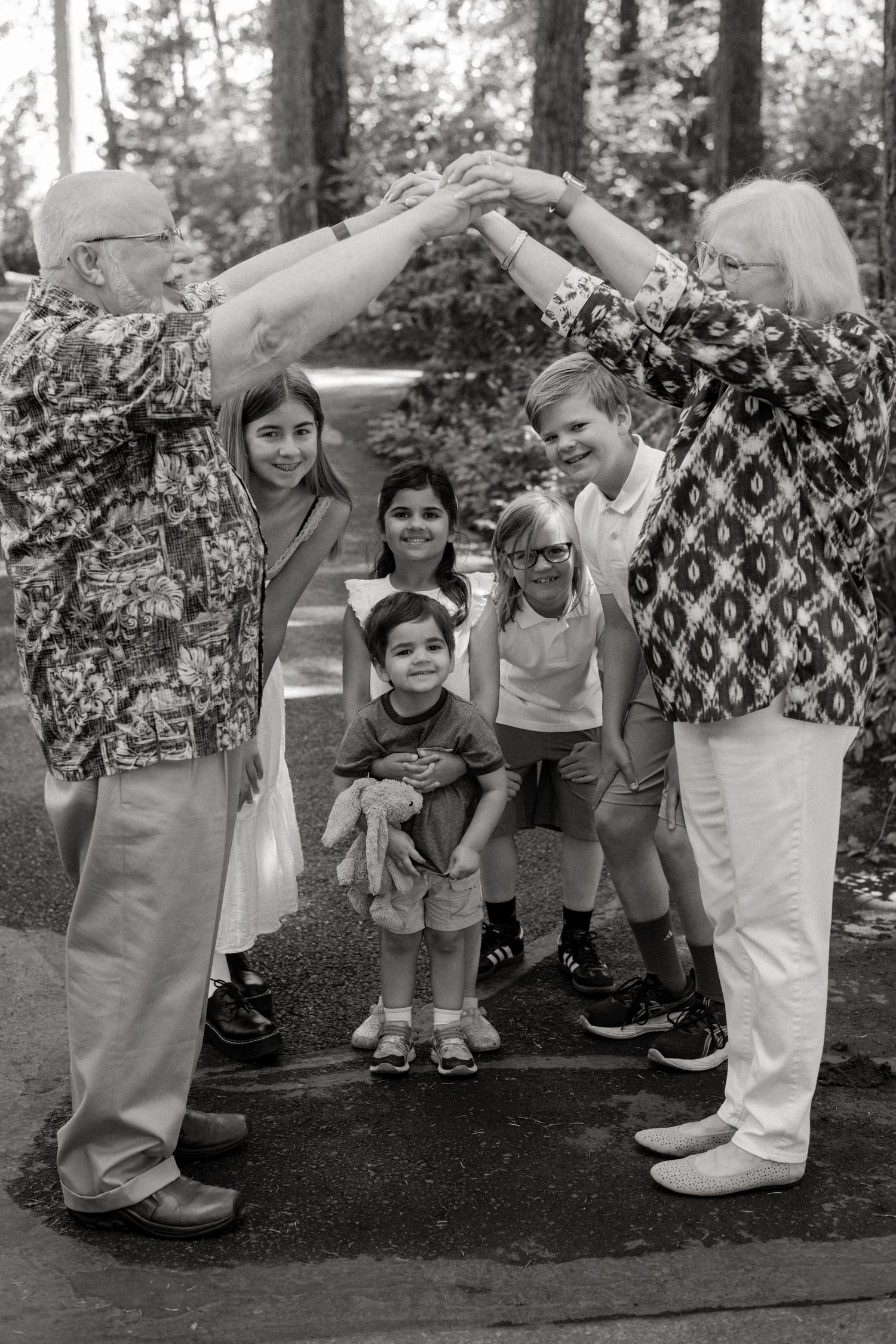 Kids play and laugh together during a fun group activity in a wooded outdoor setting.